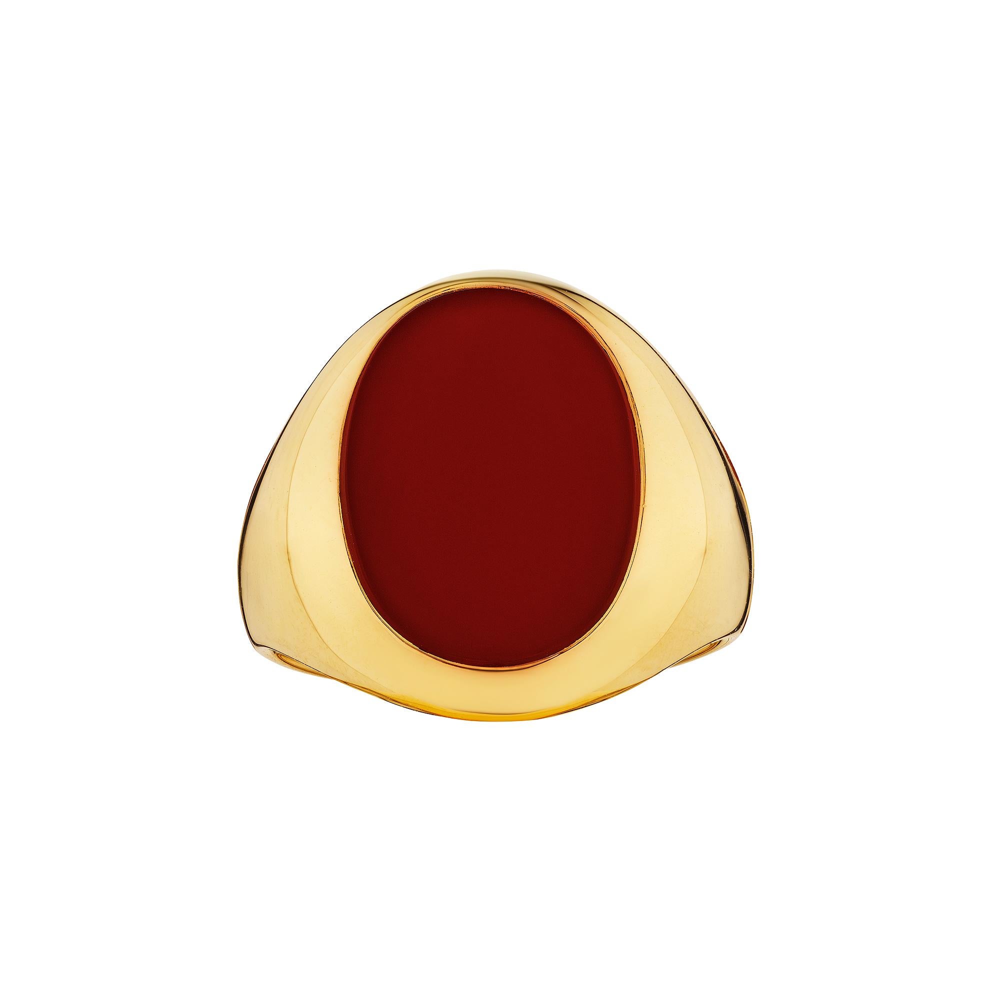 This Cartier oval cut carnelian and 18 karat yellow gold modernist signet ring is handsomely stylish for both a man or woman, looks great on the pinky, ring, or pointer finger, and can be hand engraved with your initials, a family crest, or simply