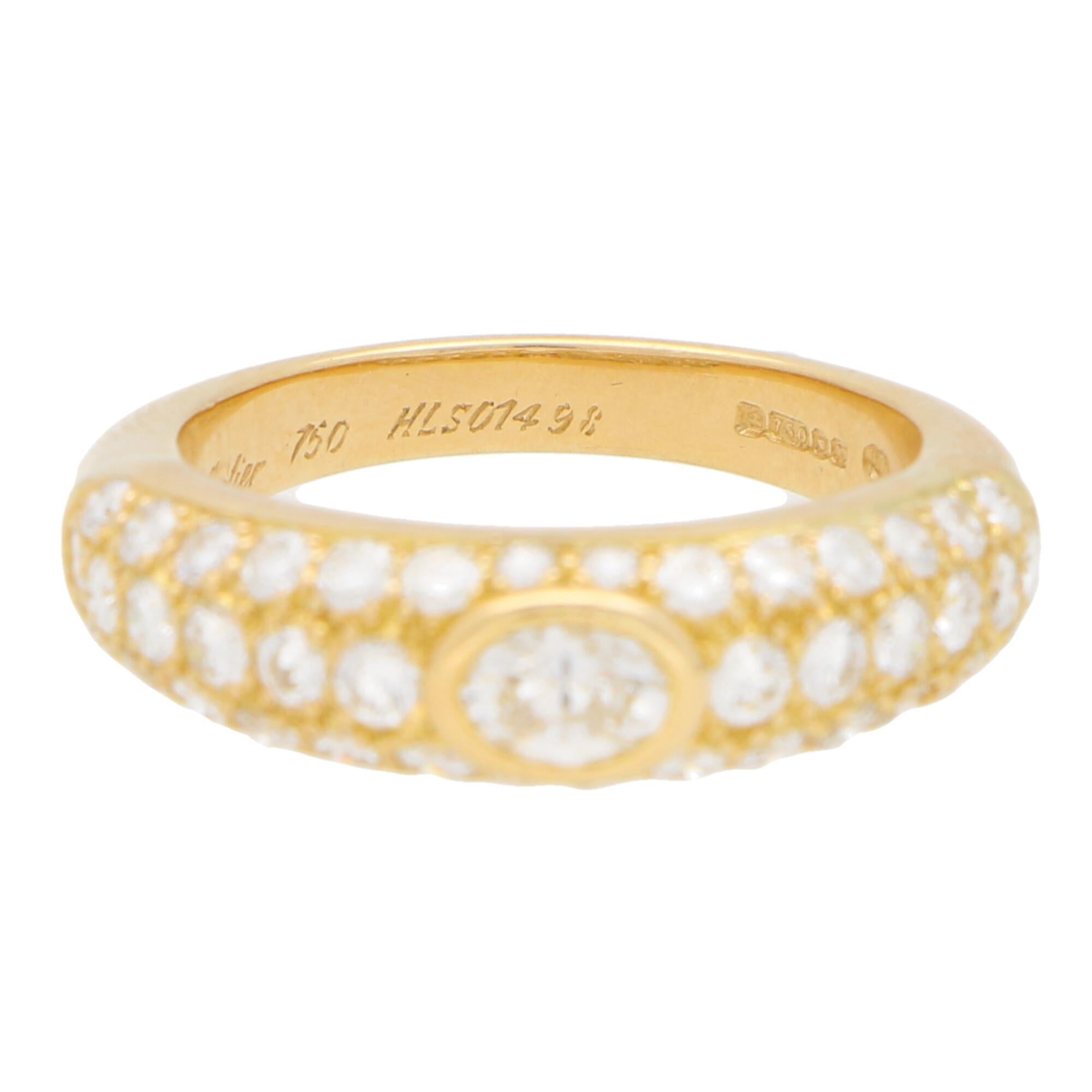 A beautiful diamond set Cartier Mimi ring set in 18k yellow gold. 

The ring is predominantly set with an extremely sparkly oval cut diamond with is securely rub over set to centre. This oval cut diamond is set amidst a half pavé set band that