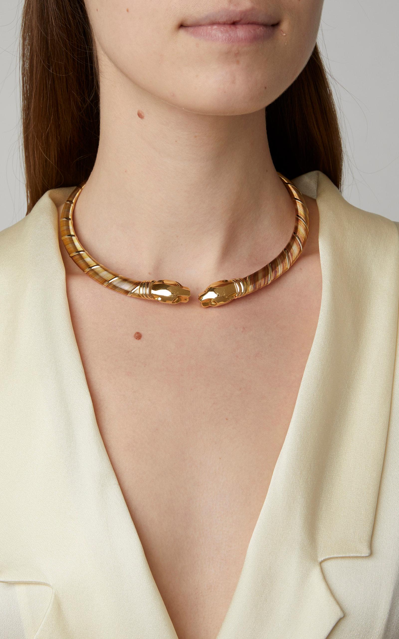 Cartier Panthère collar necklace in tri-colored 18kt gold. Structured style formed as an open collar with a ribbed design with a pair of sculpted yellow gold panther heads in front. Made in France, circa 2000. 
