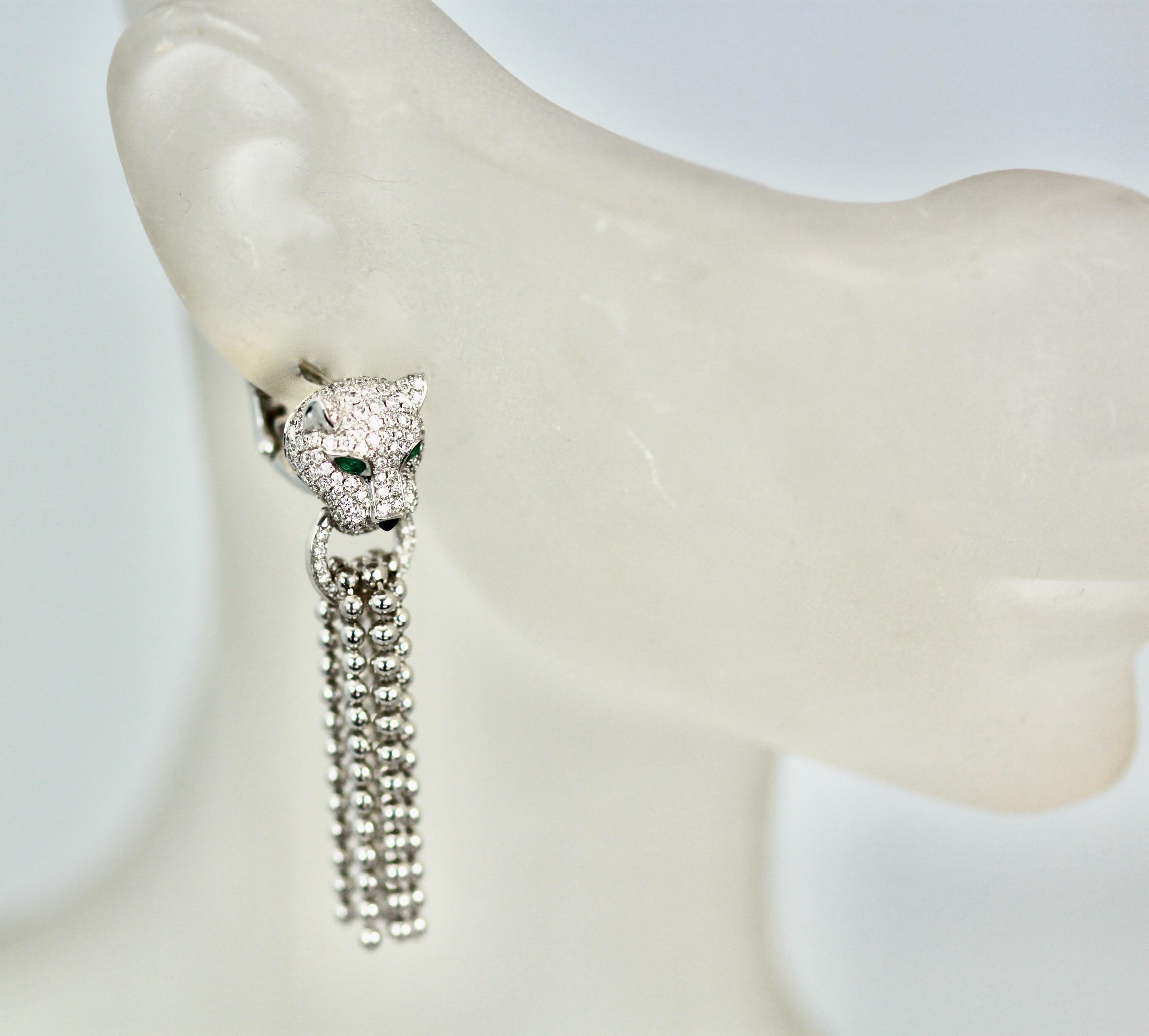 These gorgeous Diamond Panthere Earrings currently retail for $52,000.  The heads are Pantheres covered in Diamonds with Emerald Eyes 3 tassels in from and 3 tassels in back to total 6 tassels.  They are 25cm long w/circle through mouth, onyx nose. 