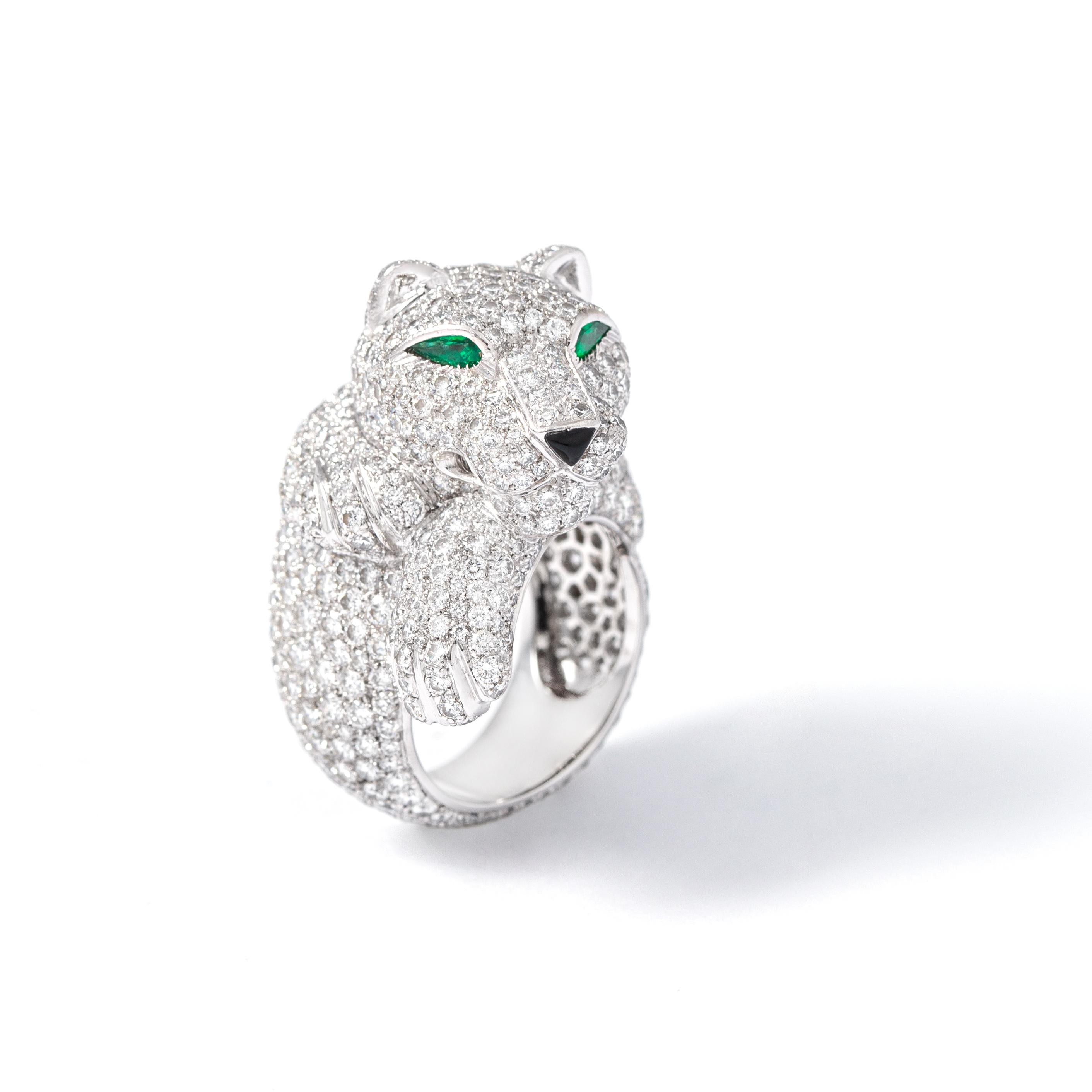 Cartier Panthere Pave Diamond Emerald White Gold Ring

18K white gold Ring overall set with round Diamonds representing a panther, the eyes in emerald and the nose in onyx.
Signed Cartier. French mark (eagle head) and maker's mark. Numbered 78048B.