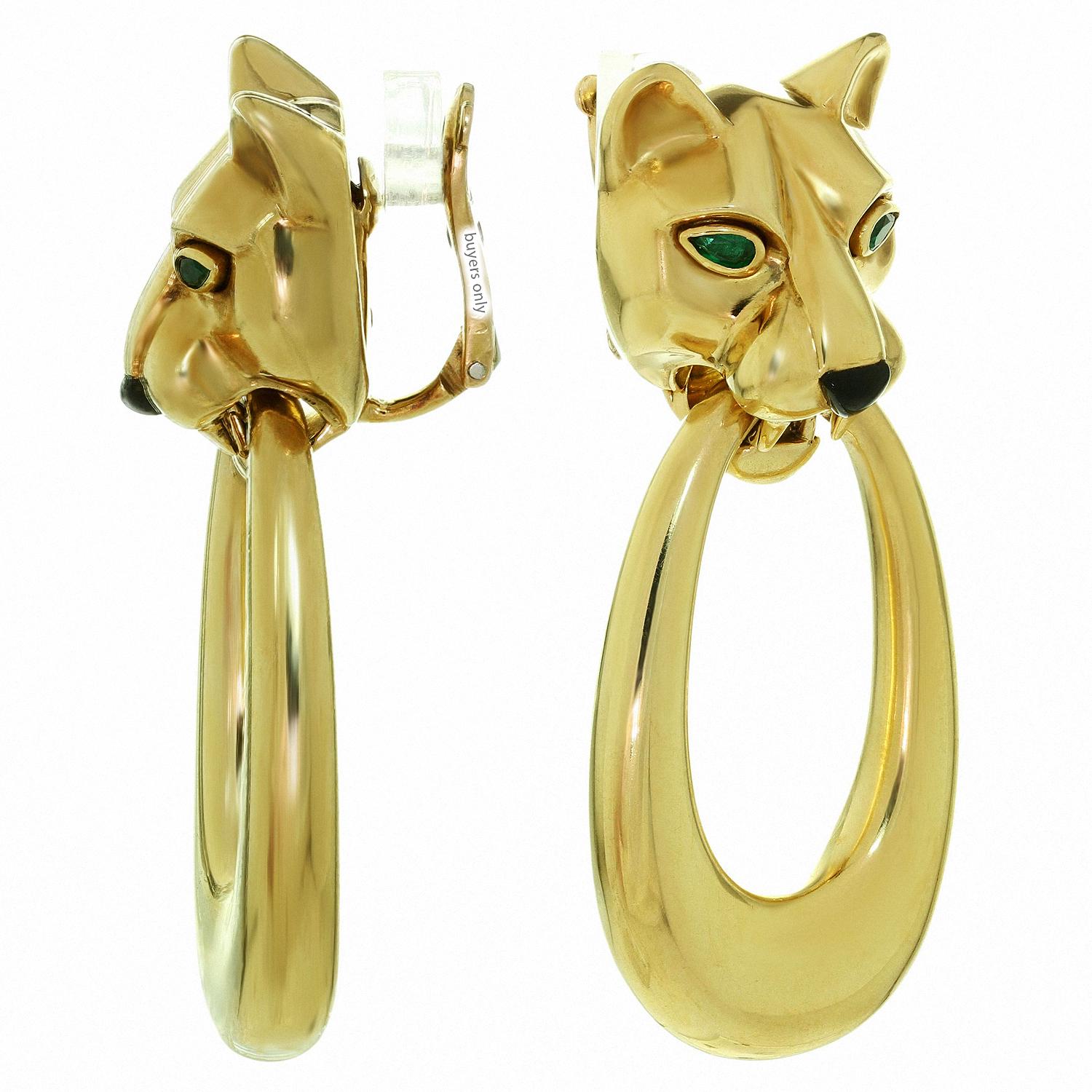 These gorgeous iconic Cartier clip-on earrings features a door-knocker design with panther heads and detachable hoops crafted in 18k yellow gold. The felines are accented with green 3.0mm pear-shaped emerald eyes and black enamel noses. Made in