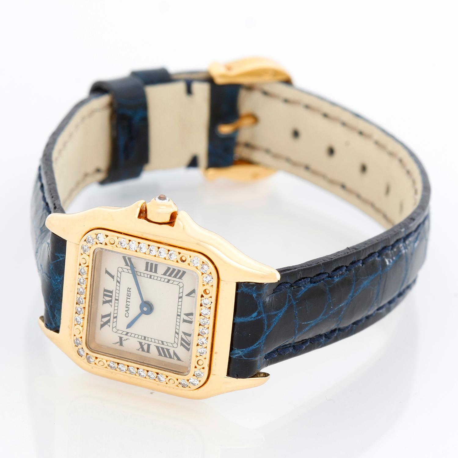 Cartier Panther Ladies 18k Yellow Gold Diamond on Strap - Quartz. 18k yellow gold case with factory diamond bezel (21mm x 30mm). Ivory colored dial with black Roman numerals. Blue leather strap with tank buckle . Pre-owned with custom box.