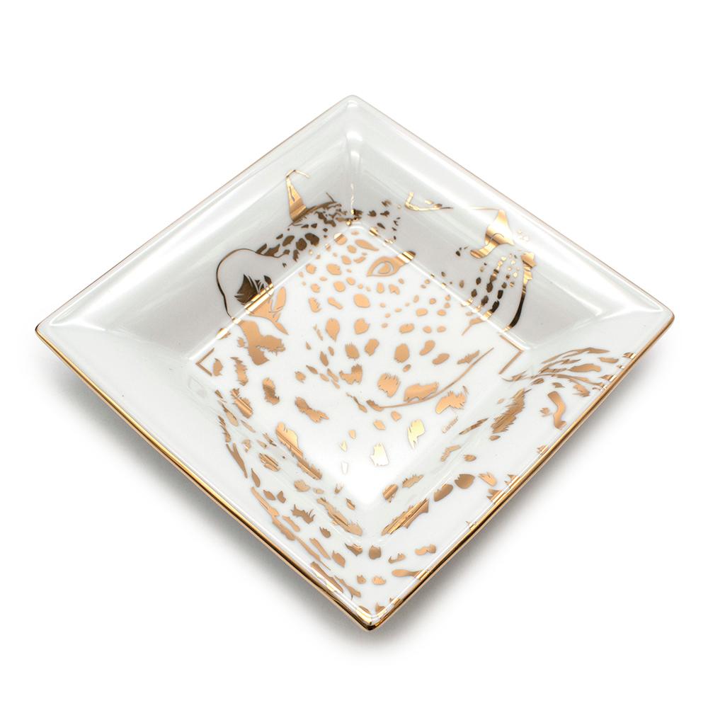 Cartier Panther Motif Porcelain Medium Trinket Tray 

Appointed Cartier's artistic director of high jewellery in 1933, Jeanne Toussaint conceptualised striking designs that remain iconic to this day. The Panther became her fingerprint and remains a
