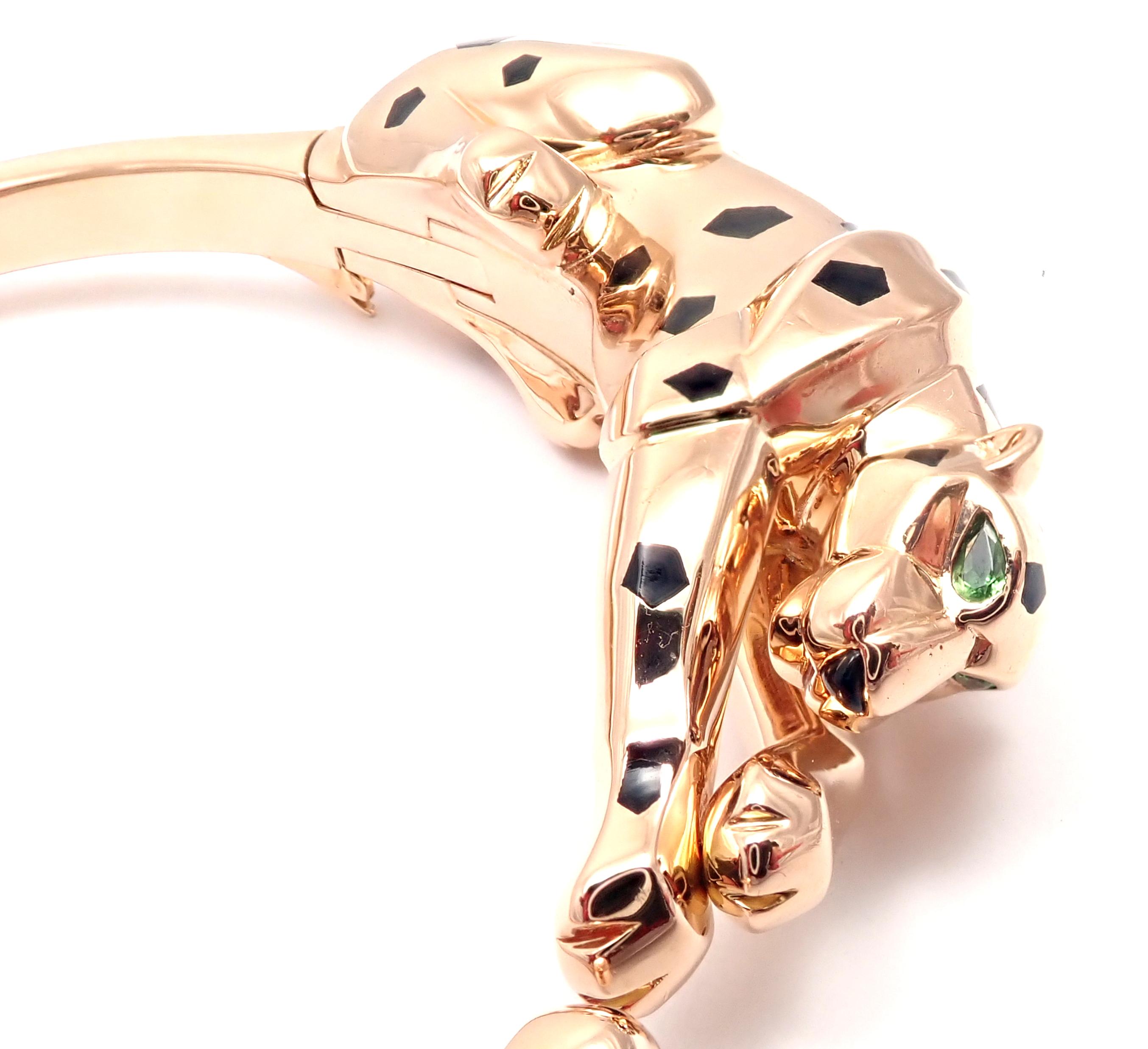 18k Rose Gold Panther Panthere Tavorite Onyx Panther Bangle Bracelet by Cartier.
With 2 Tsavorite Garnets in the eyes, 1 black onyx nose and black lacquer.
This beautiful bracelet comes with its original Cartier box and a service paper from Cartier