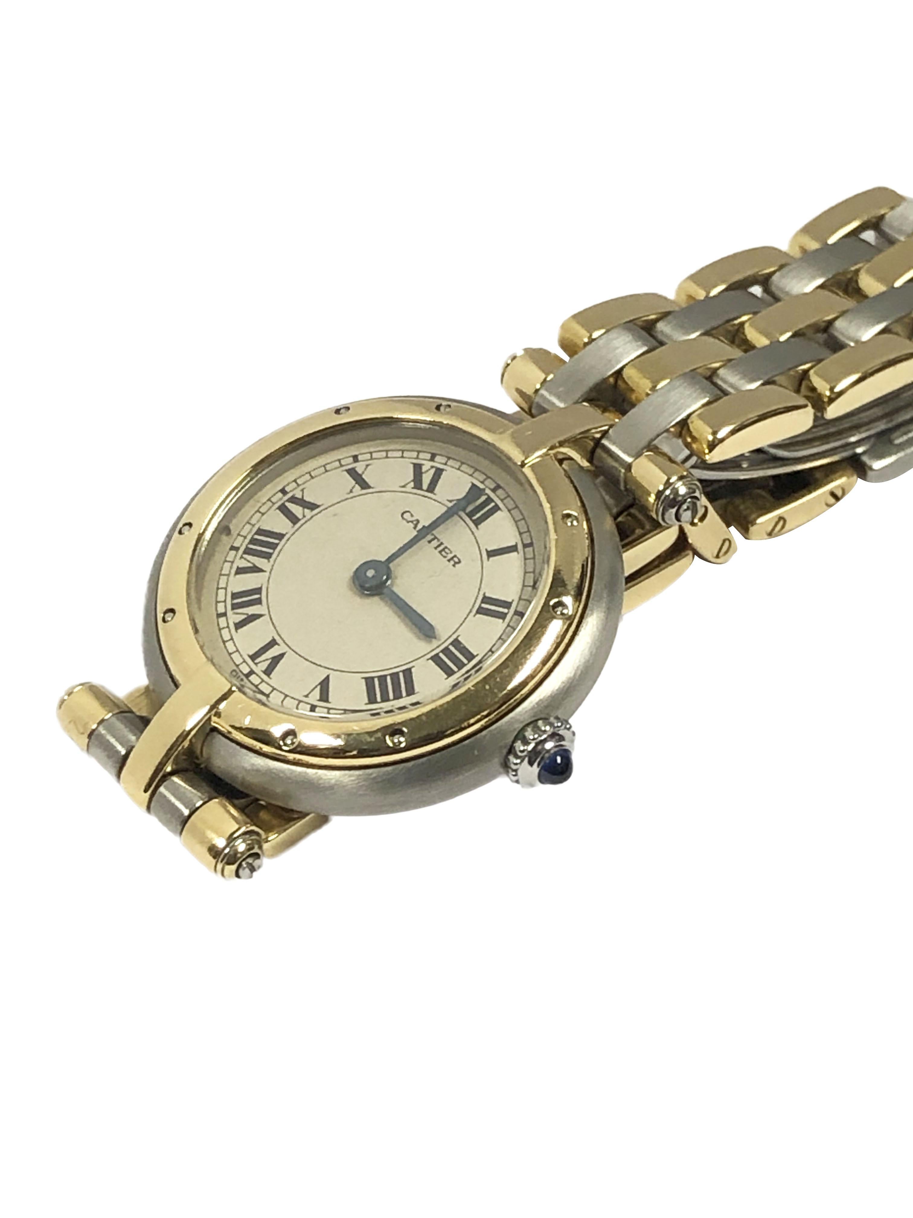 Circa 1990s Cartier Panther Ronde Collection Ladies Wrist watch, 24 MM Stainless Steel Case with 18K yellow Gold Bezel, Quartz Movement, Silver Satin Dial with Black Roman Numerals and a Sapphire Crown. 1/2 inch wide 18K and Stainless Steel 3 Stripe