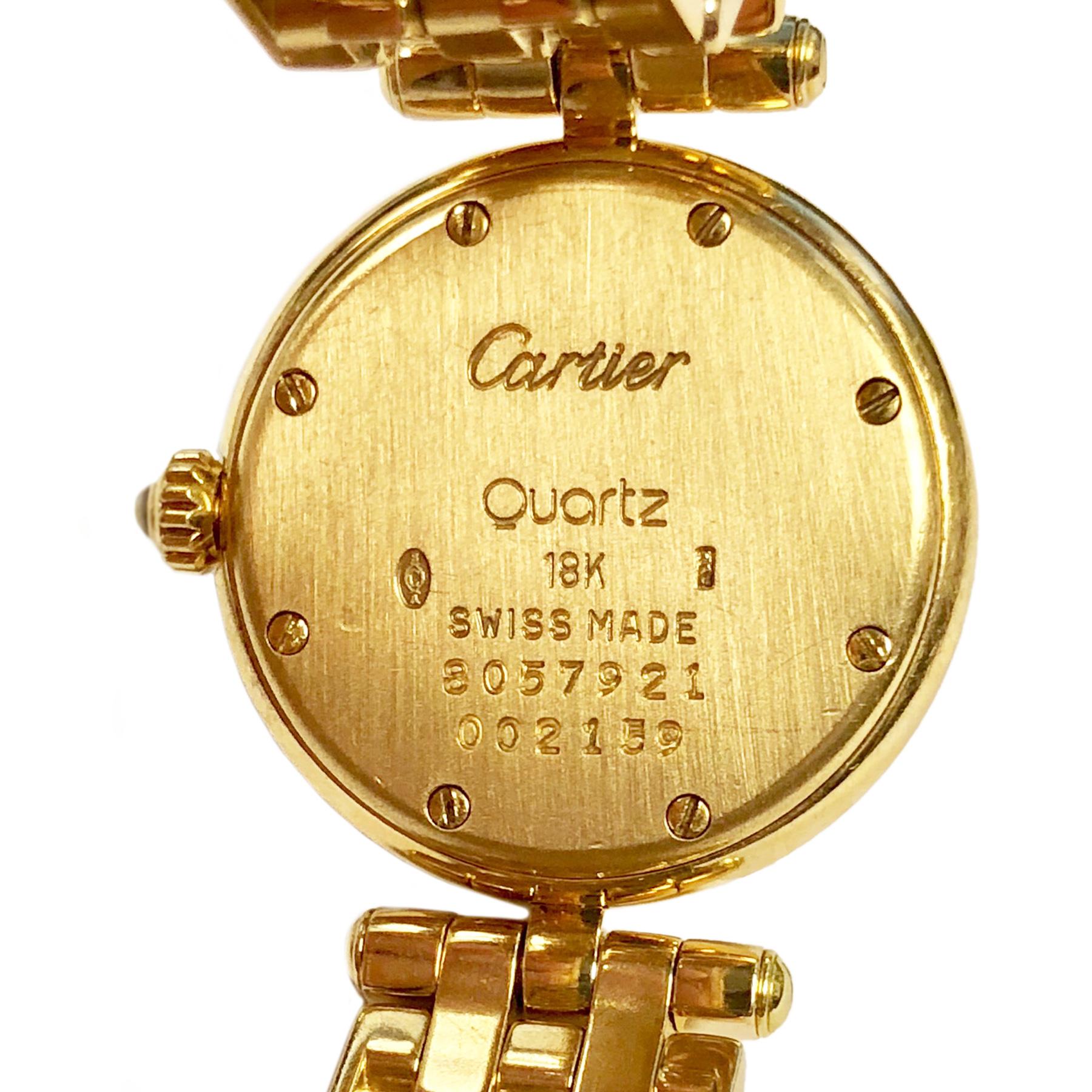 Circa 1990 Cartier Panther Ronde Ladies Wrist watch, 24 MM 18K Yellow Gold Case, Quartz movement,  White dial with Black Roman numerals and a  Sapphire Crown. 1/2 inch wide panther link Bracelet with fold over deployment clasp. Watch length just