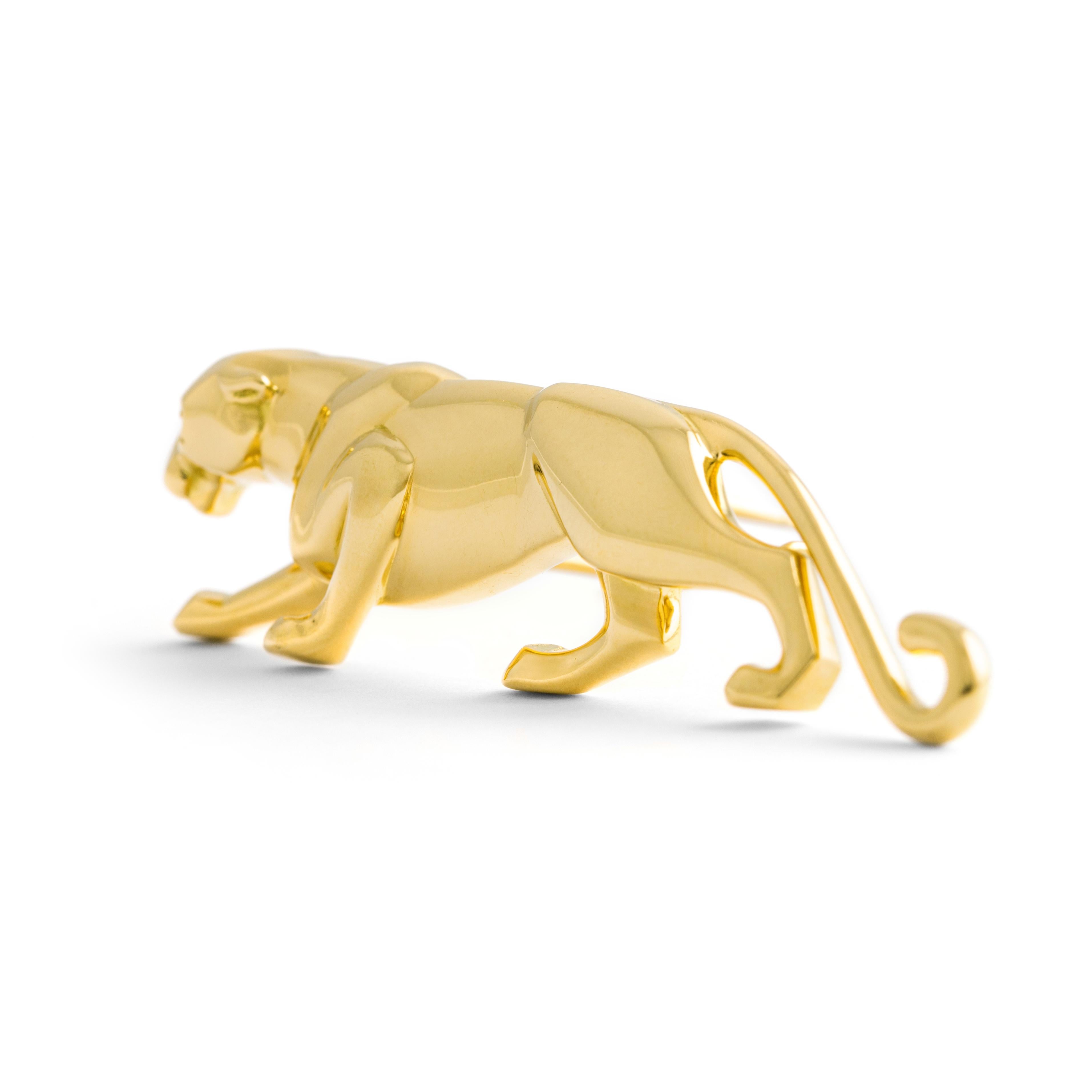 Cartier Panther yellow gold 18K brooch.

This Cartier Panther brooch is crafted in 18K yellow gold, featuring an emerald eye that adds a touch of vivid elegance. The piece is signed Cartier, numbered, and marked, ensuring its authenticity and