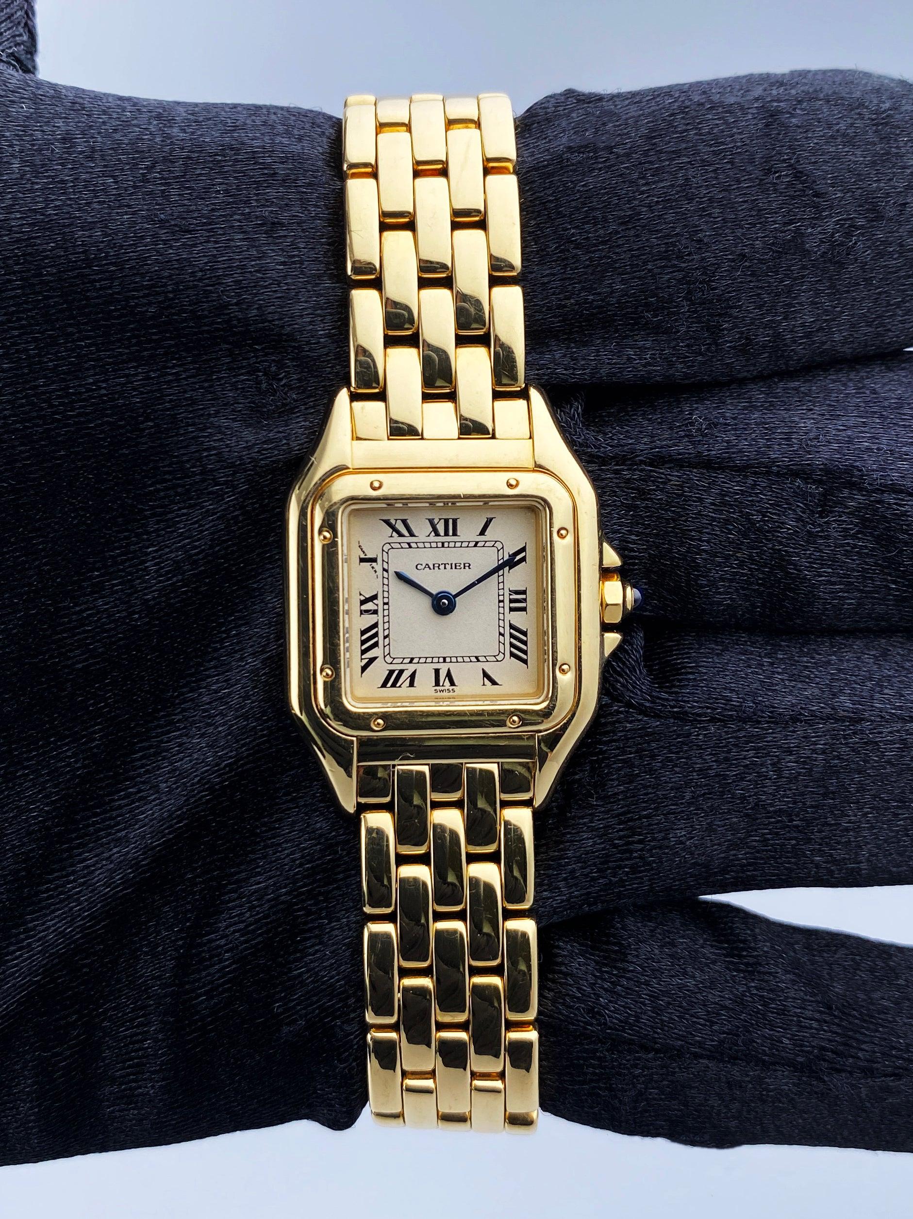 Cartier Panthere 1070 Ladies Watch. 22mm 18K yellow gold case. 18K yellow gold smooth bezel. Off-white dial with blue steel hands and Roman numeral hour markers. Minute markers on the inner dial. 18K yellow gold bracelet with hidden butterfly clasp.