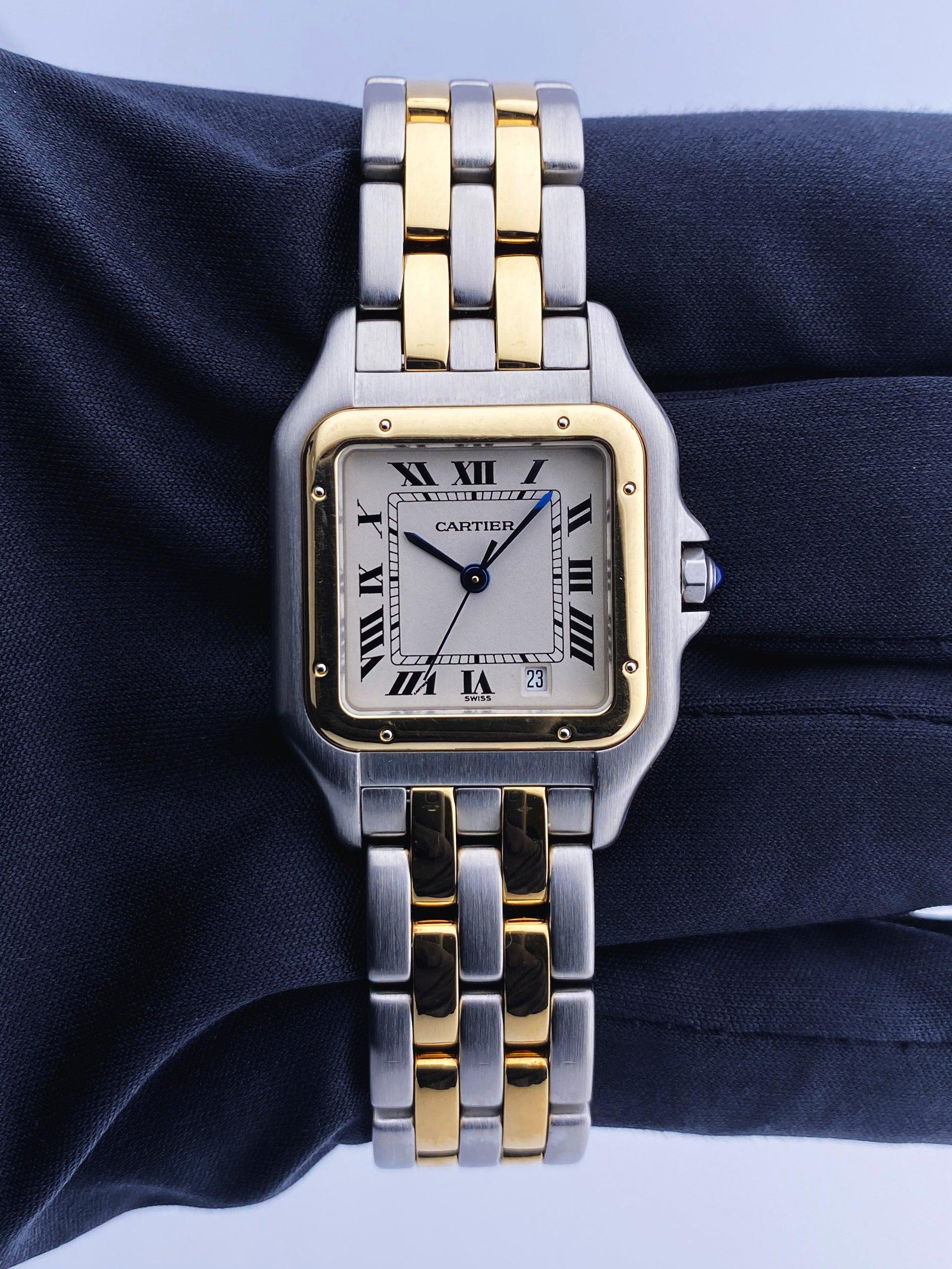 Cartier Panthere 1100 Midsize Ladies Watch. 27mm stainless steel case with a 18K yellow gold bezel. Off-White dial with blue steel hands and black Roman numerals hour markers. Date display at the 5 o'clock position. Two-tone stainless steel and 18K