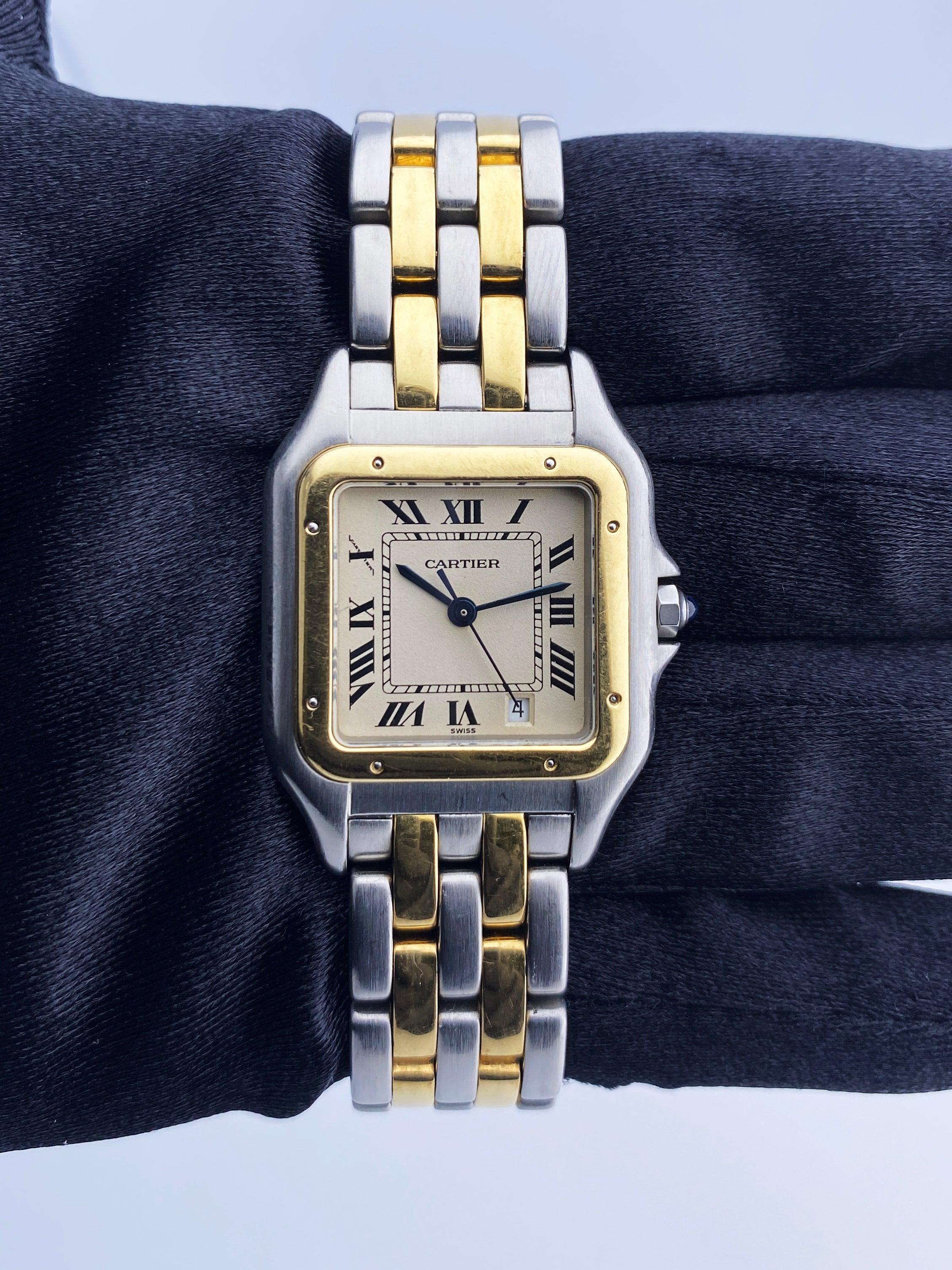 Cartier Panthere Midsize 183949 Ladies Watch. 27mm stainless steel case. 18K yellow gold fixed bezel. Off-White dial with blue steel hands and Roman numeral hour markers. Minute markers on the inner dial. Date display at the 5 o'clock position.