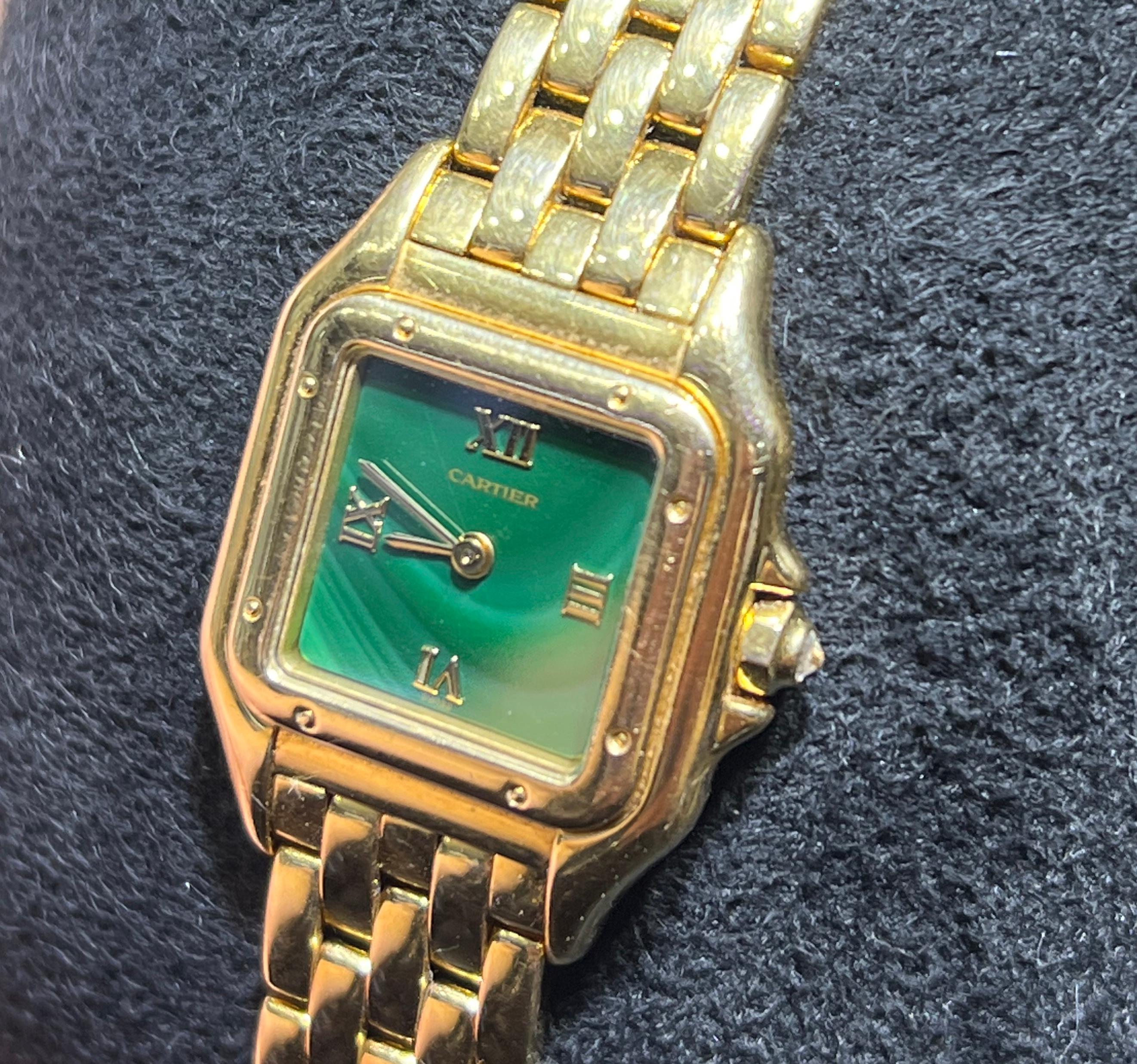 Beautiful watch by Cartier. The model is known as the Panthère and is crafted in solid 18k yellow gold. The watch is model number 1280 2. The rarity of the timepiece is in the dial. The dial is a Malachite gemstone dial with gold roman numerals. The