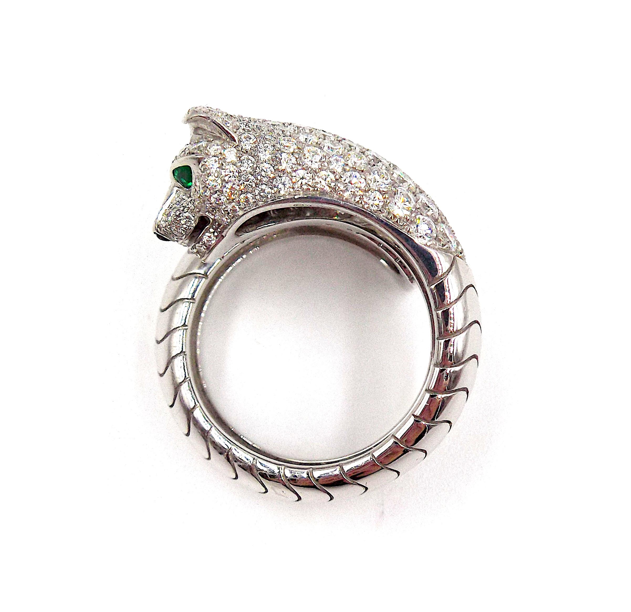 Made of 18k white gold and set with round-cut diamonds. The panther's eyes are accented with tsavorite garnets, the nose is set with black onyx. Comes with a box and papers from Cartier (receipt for cleaning). Size 57 EU, 8 US.
Signed 