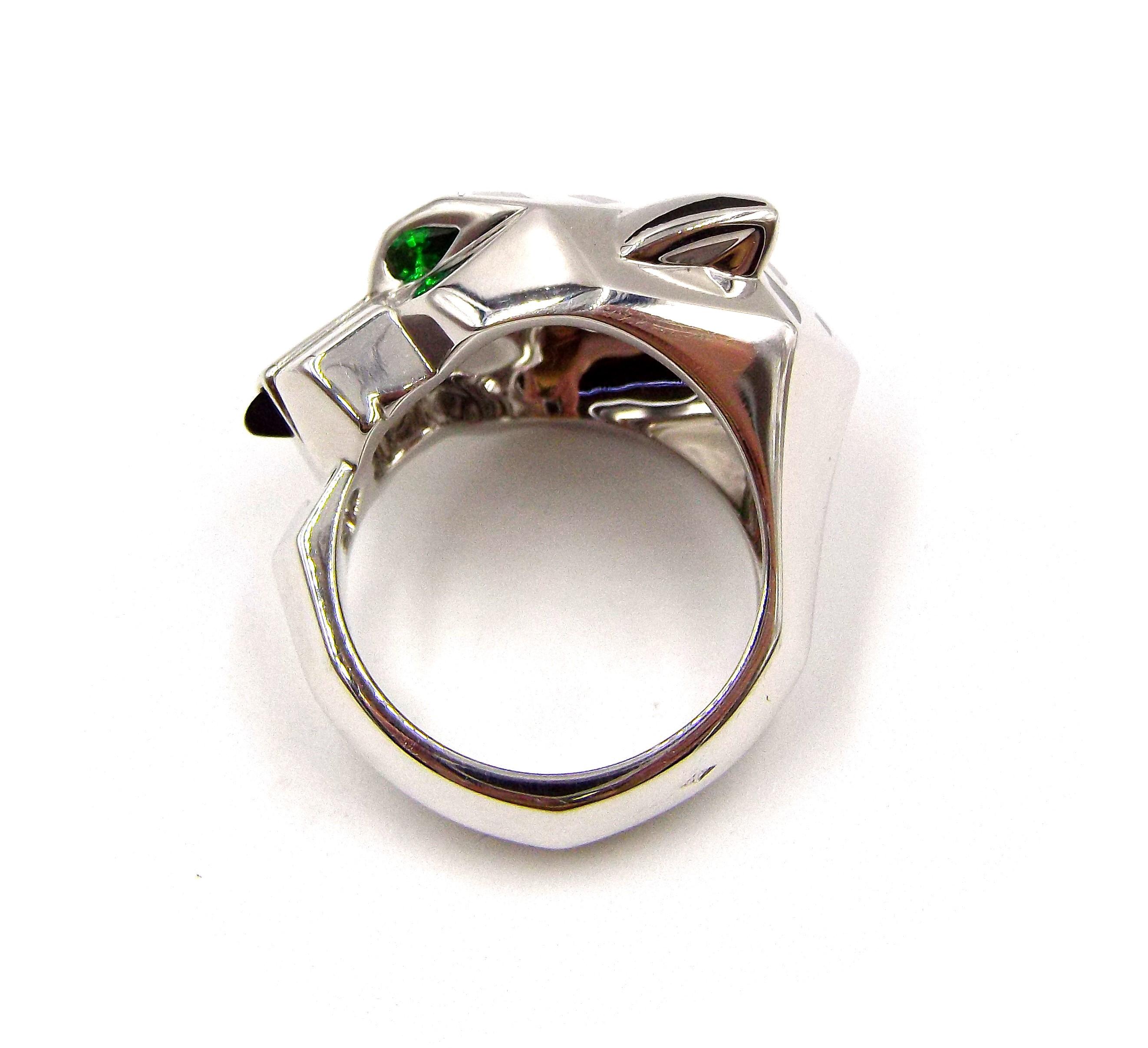 European size 56, US size 7.5. Item weight is 28.2 grams, made of 18K white gold. Eyes set with tsavorite garnets. Onyx nose, black lacquer spots. Comes with box and papers.