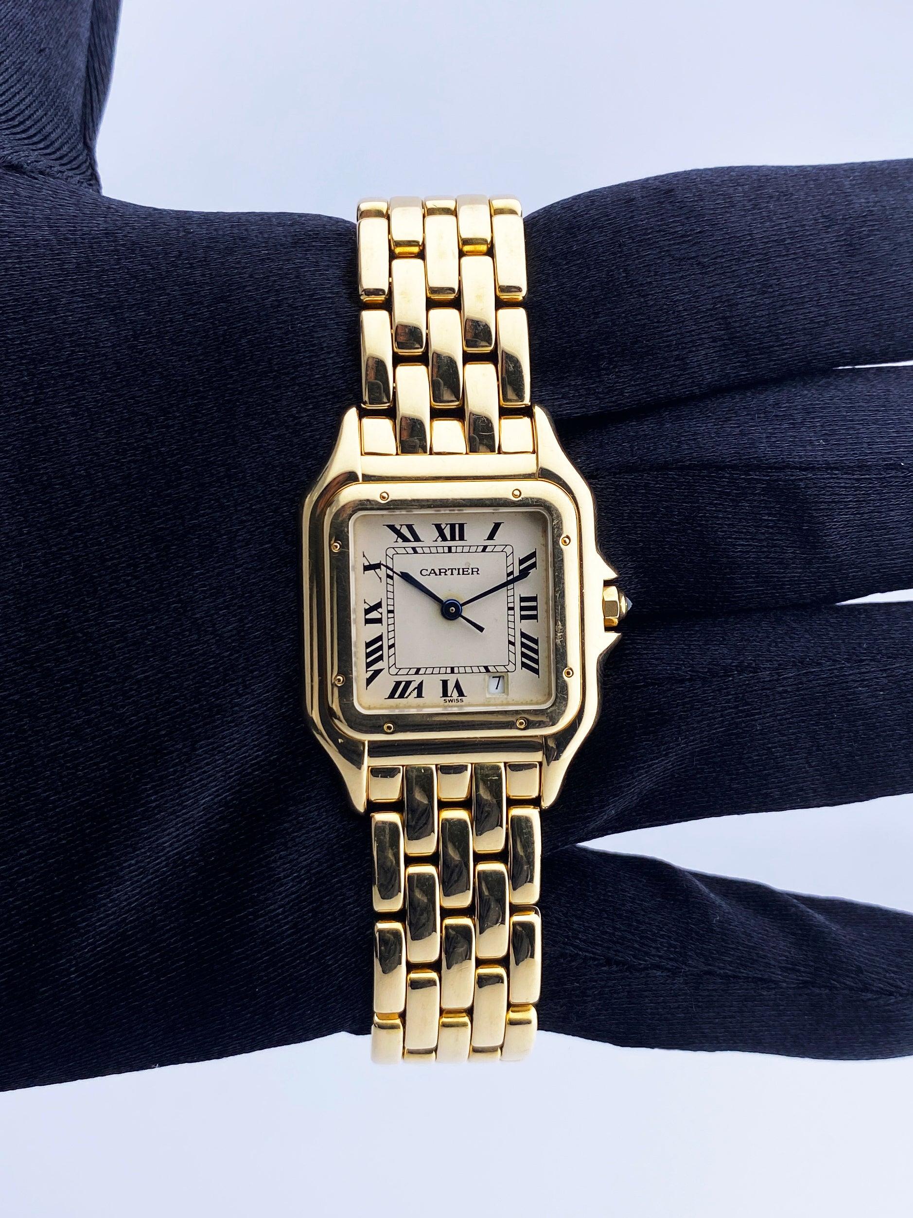 Cartier Panthere Midsize Ladies Watch. 27mm 18K yellow gold case. 18K yellow gold bezel. Off-White dial with blue steel hands and Roman numeral hour markers. Minute markers on the inner dial. Date display at the 5 o'clock position. 18K yellow gold