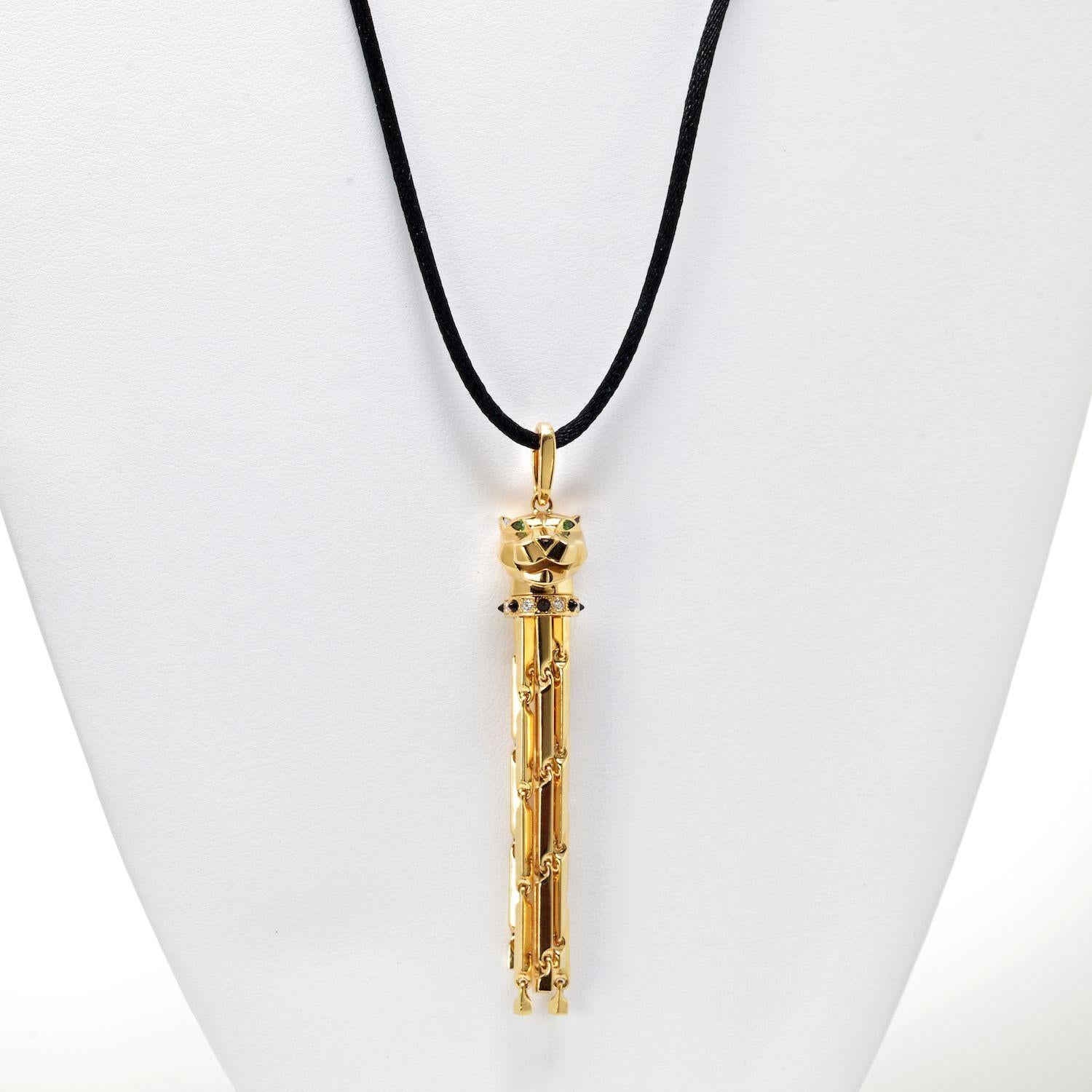 18 kt. yellow gold Panthere Sautoir necklace by Cartier. The necklace features a Panthere's head, with tsavorites set to the eye's and black onyx to the nose. The necklace has onyx and diamonds set to the collar of the Panthere, with 6 freely moving