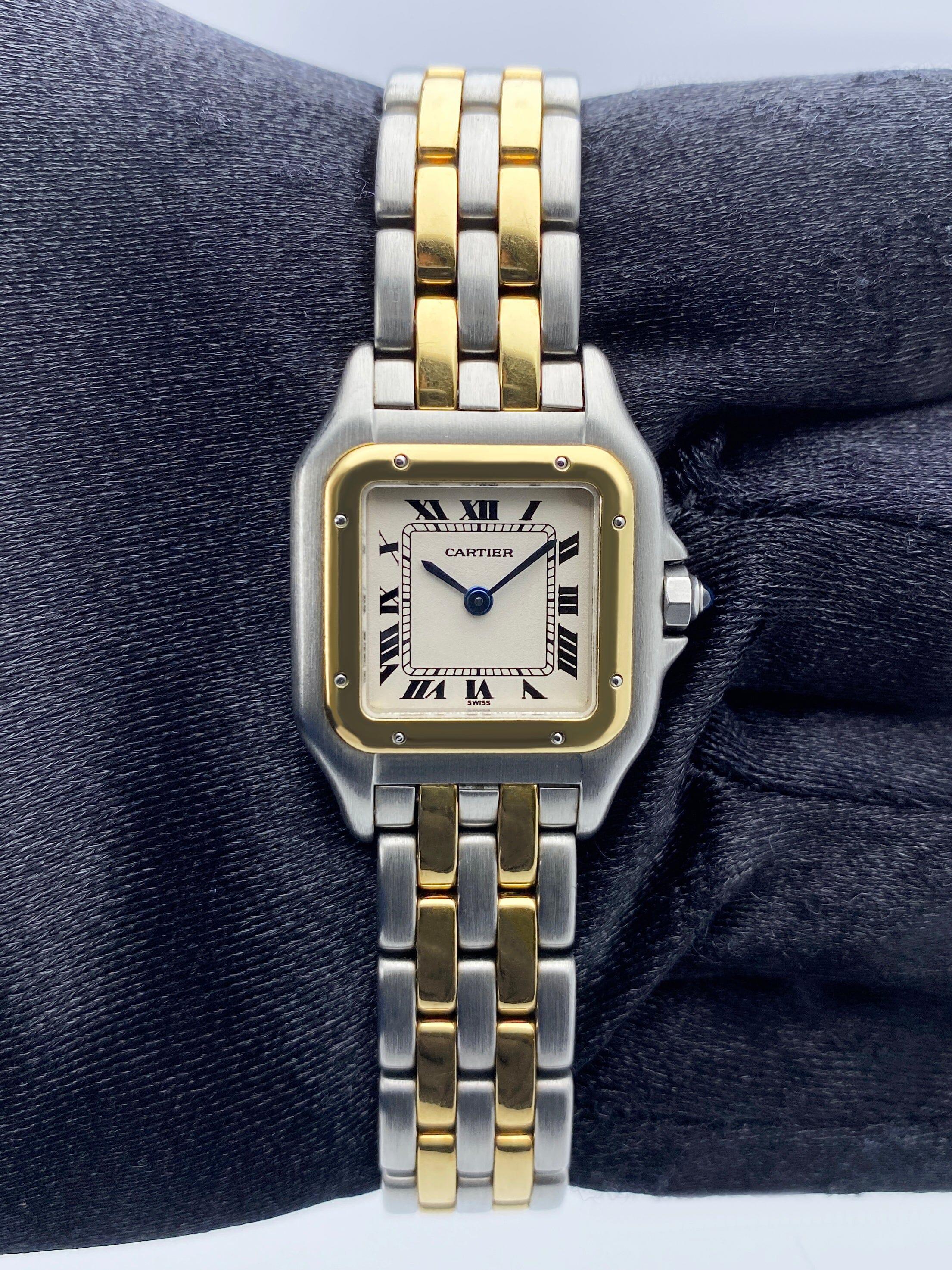 Cartier Panthere Ladies Watch. 22mm stainless steel case. 18K Yellow Gold bezel. Off-white¬†dial with Blue steel hands and Roman numeral hour markers. Minute markers on the inner dial. Stainless steel & two¬†rows of 18K yellow gold ¬†bracelet with
