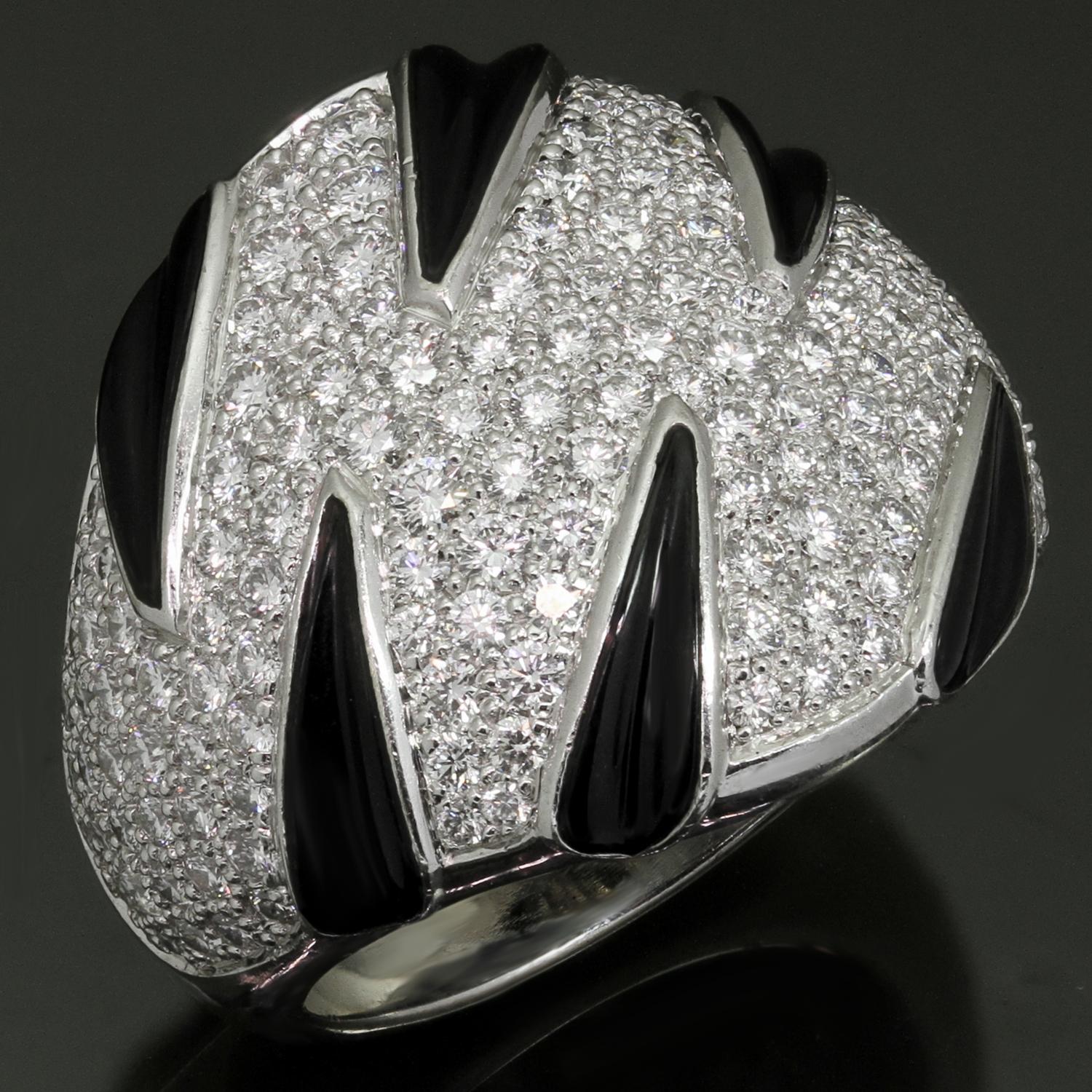 This fabulous Cartier dome ring from the chic Panthere Claws collection is crafted in 18k white gold, accented with black onyx, and pave-set with round brilliant D-E-F VVS1-VVS2 diamonds. Made in France circa 2000s. Measurements: 0.90