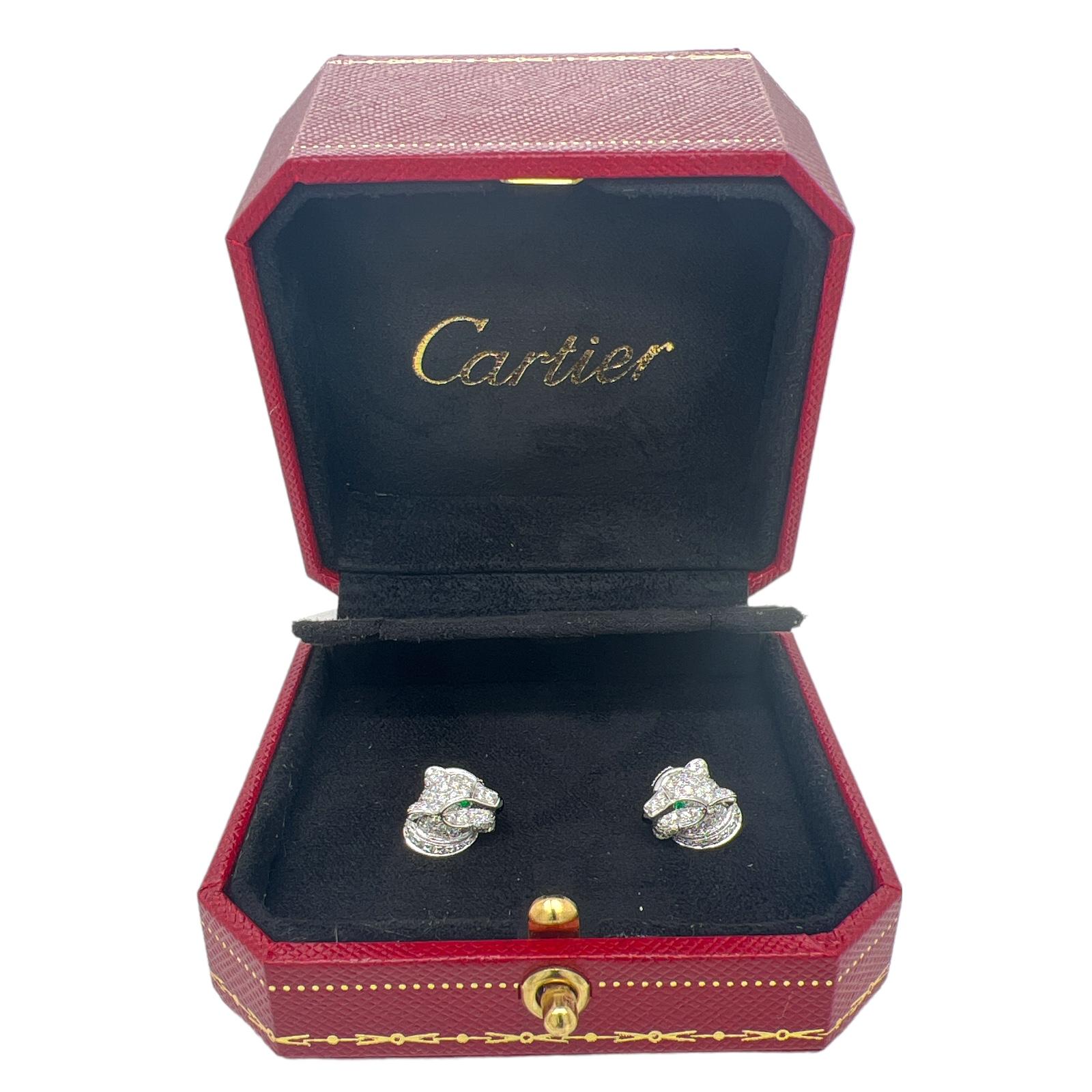 Beautiful Cartier Panthére diamond earrings crafted in 18 karat white gold. The earrings feature 63 round brilliant cut diamonds weighing approximately .77 CTW, round emerald eyes, and onyx nose. The earrings measure 12.7mm in width. Come with