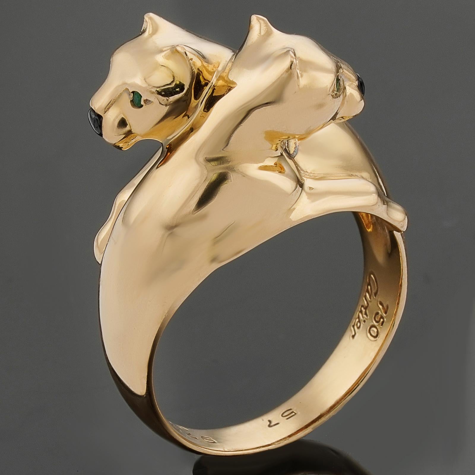 This gorgeous authentic Cartier ring from the iconic Panthere de Cartier collection is crafted in 18k yellow gold and features an intertwined double panther head design accented with a black onyx nose and green emerald eyes. Made in France circa