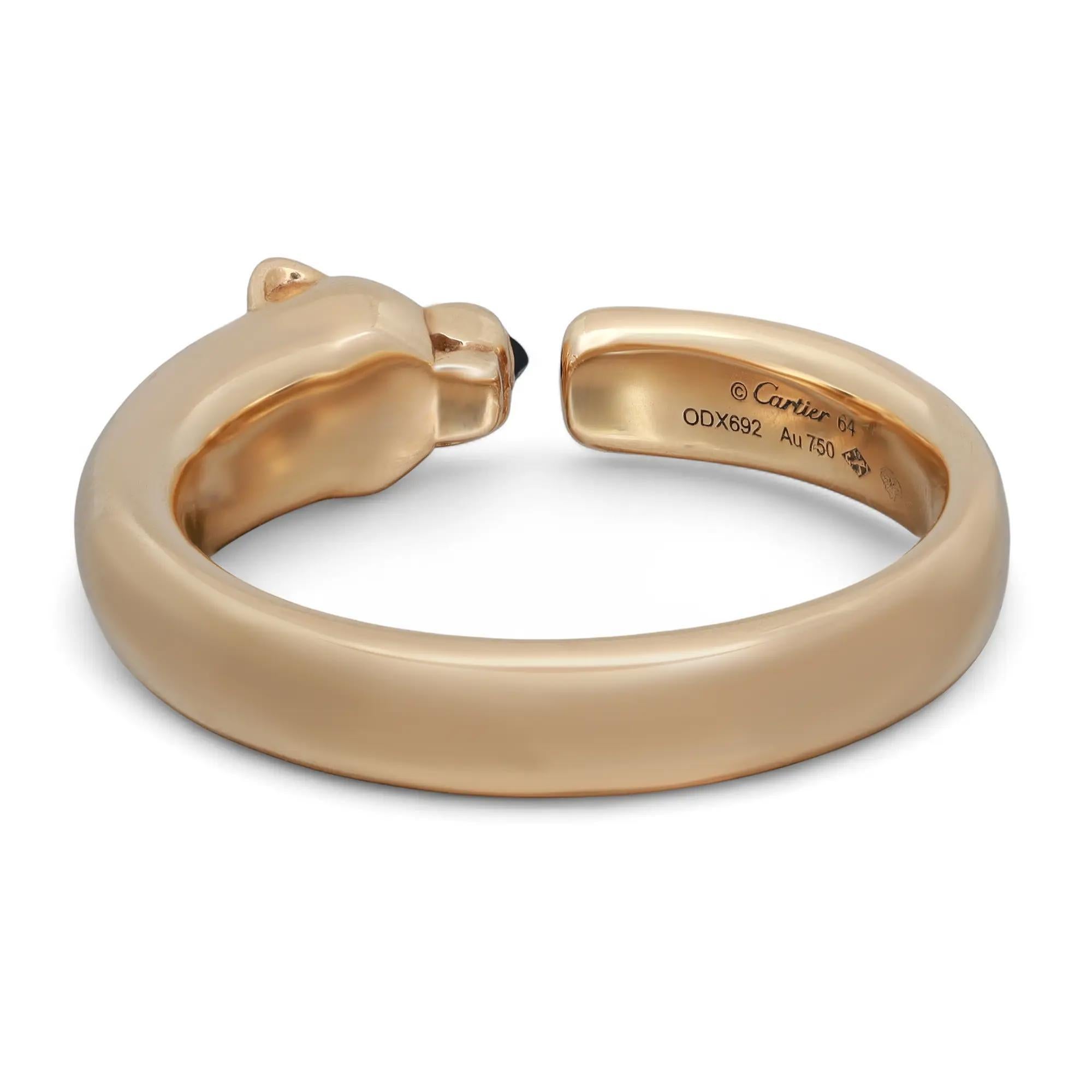 The fierce and playful Cartier Panthere De Cartier Ring, Small Model is crafted in 18k yellow gold. It features a panthere head studded with 2 green Tsavorite garnets for eyes and black onyx for nose with body formation in ring. Ring size: EU 64, US