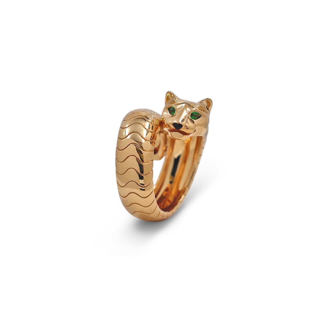 Authentic Cartier ring from the Panthère de Cartier collection centering on a single panther, an iconic symbol of the house. The ring is crafted in 18 karat yellow gold. The panther is completed with tsavorite garnet eyes and a carved black onyx