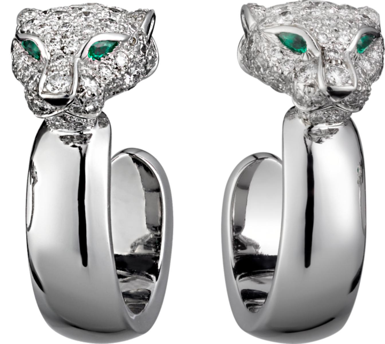 An incredible pair of iconic Cartier earrings from the Panthere collection, each Panthere head motif is adorned with the finest original Cartier round brilliant cut diamonds and 2 emeralds suspending a white gold hoop. The earrings include the