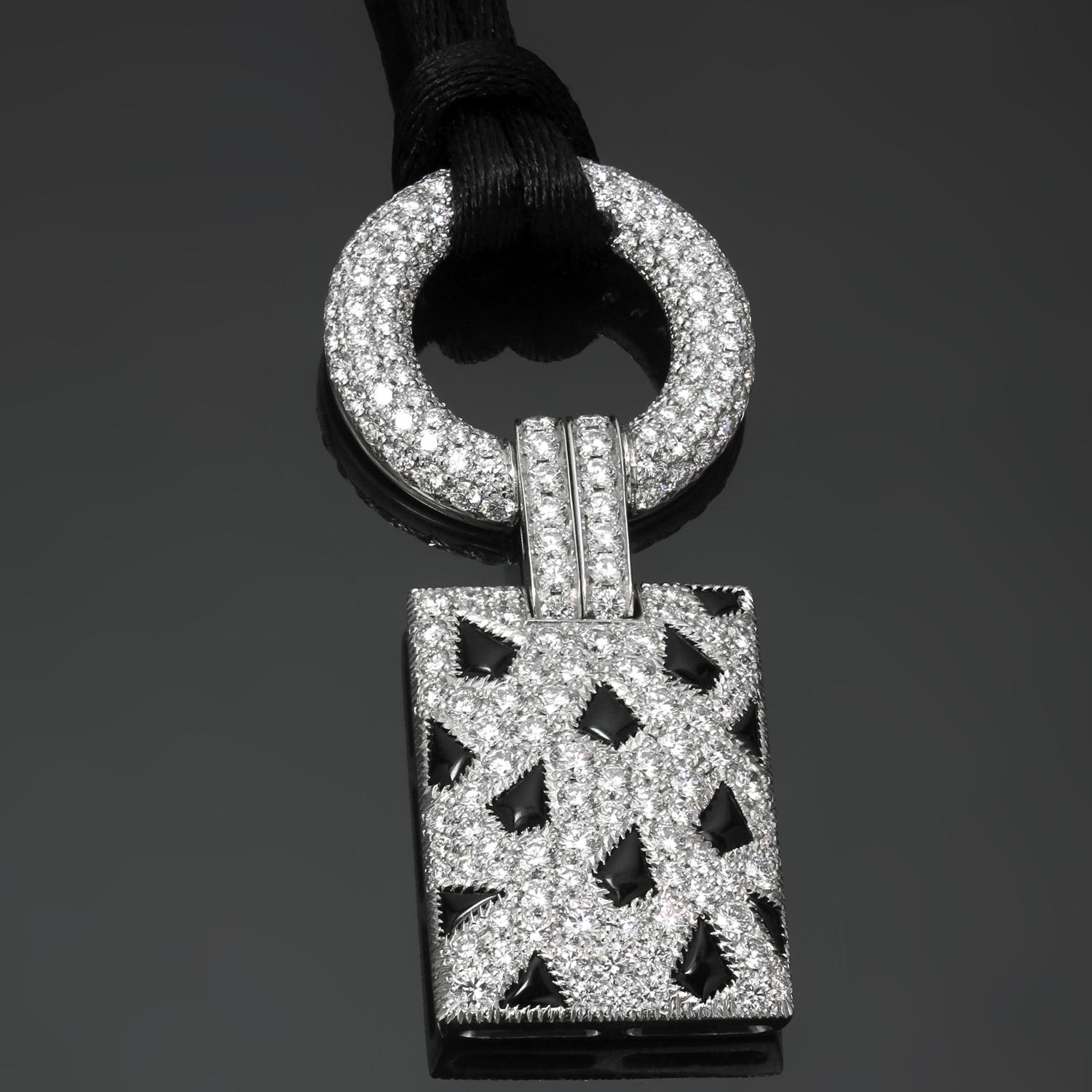 This exquisite Cartier necklace features a sparkling 18k white gold rectangular-shaped pendant with shield-shaped black onyx spots, topped by a pave-set diamond circle link joined by a pair of diamond-set bands. The total diamond weight is an