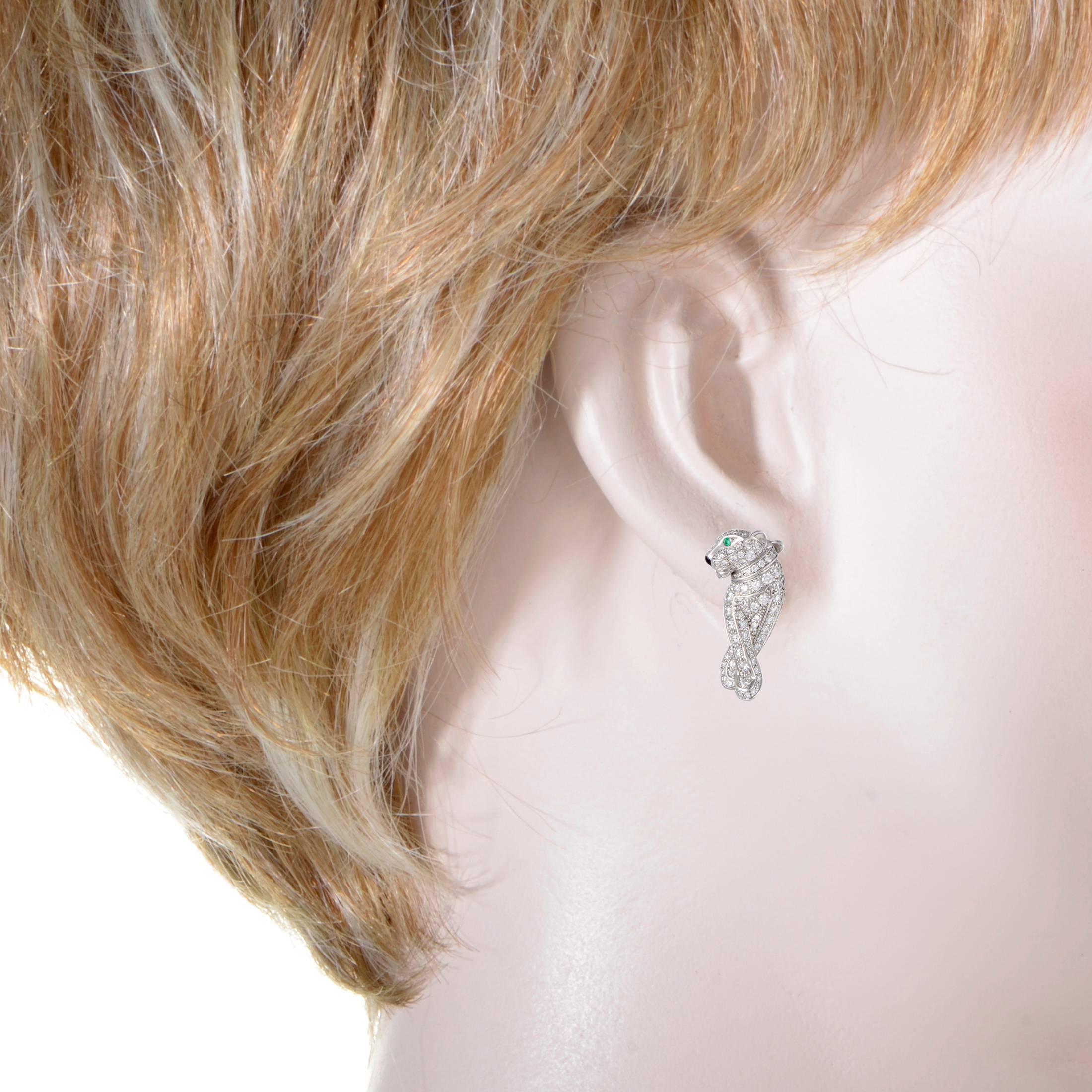 Crafted from elegant 18K white gold and depicting panthers in an endearingly graceful manner, these spectacular Cartier earrings offer a look of utmost prestige and opulence. The earrings are embellished with emeralds and 0.66 carats of