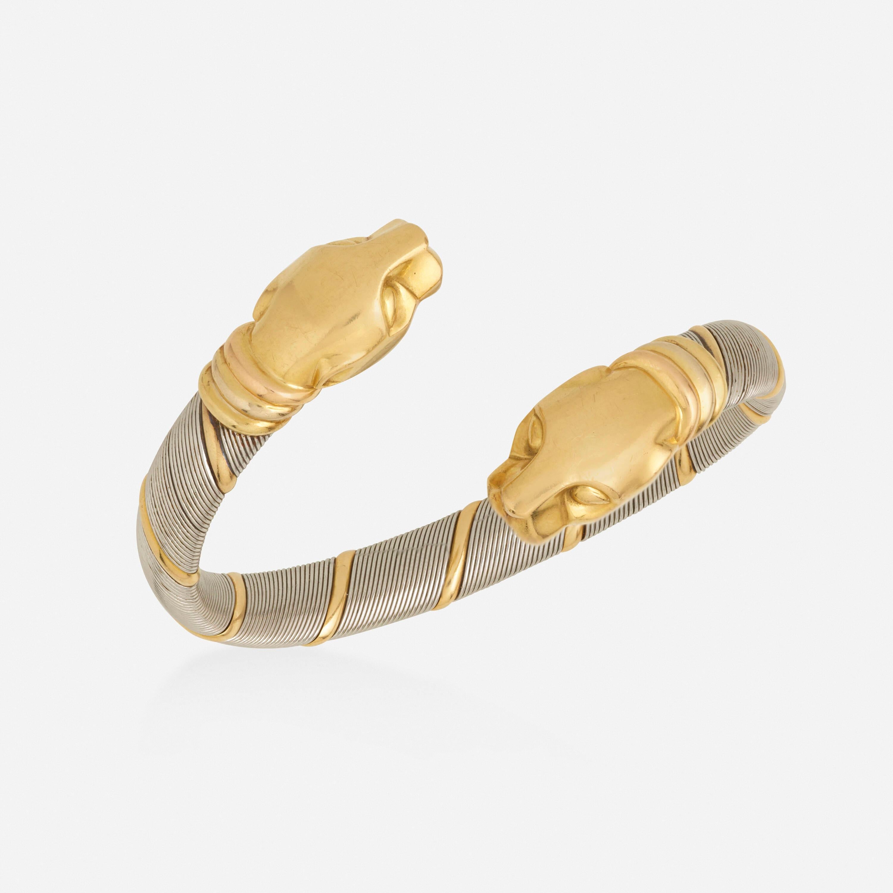 Made of steel and bars of gold, ending with two gold panther heads; 1980s
Steel and 18k yellow, white, and pink gold
Signed Cartier, numbered
Circumference 6.50 in