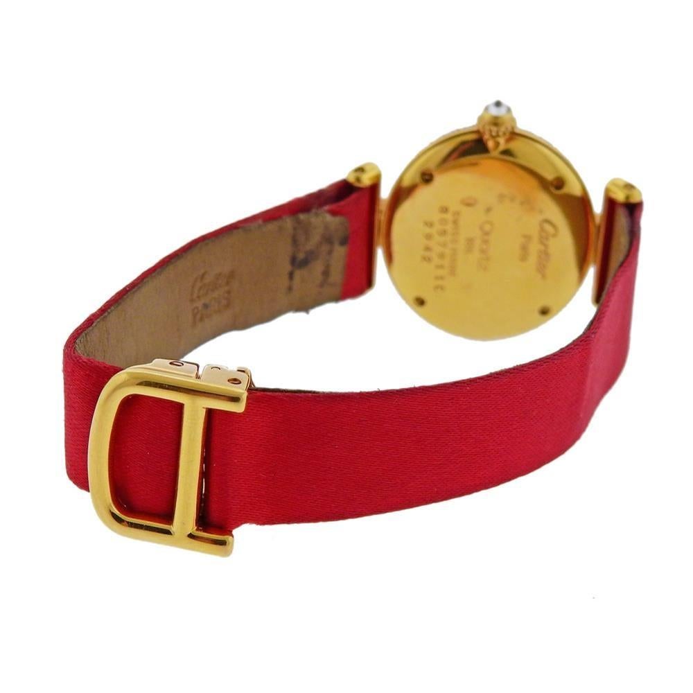 18k gold Panthere watch by Cartier, set on red satin leather Cartier band with 18k gold Cartier deployant buckle. Case is 24mm in diameter excl crown. Bracelet will fit up to 6.25