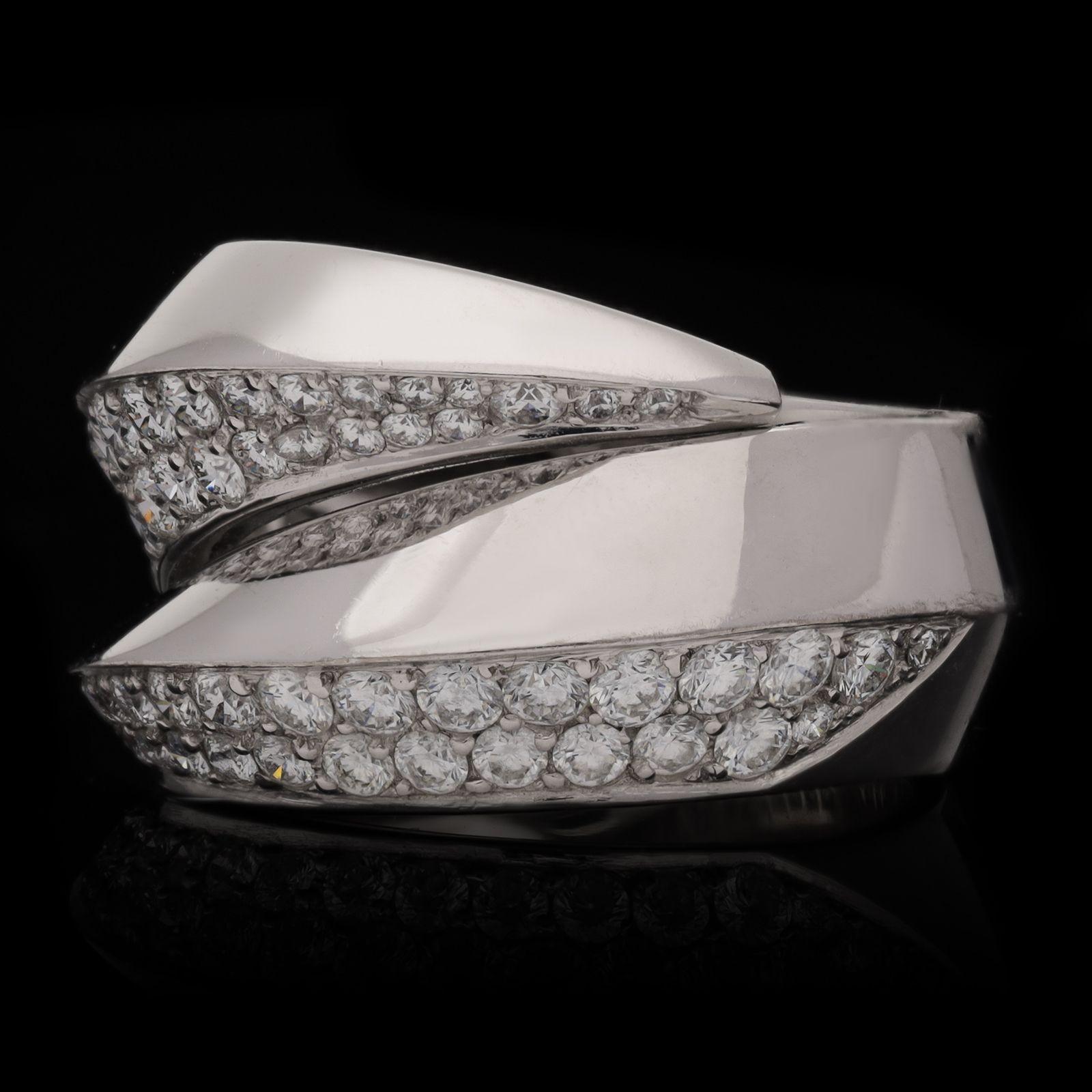 A striking 18ct white gold and diamond ‘Panthère Griffe’ ring by Cartier, c.2000s, designed as a pair of claws encircling the finger and overlapping at the front, the sharply pointed talons with a raised triangular profile, each pavé set to one