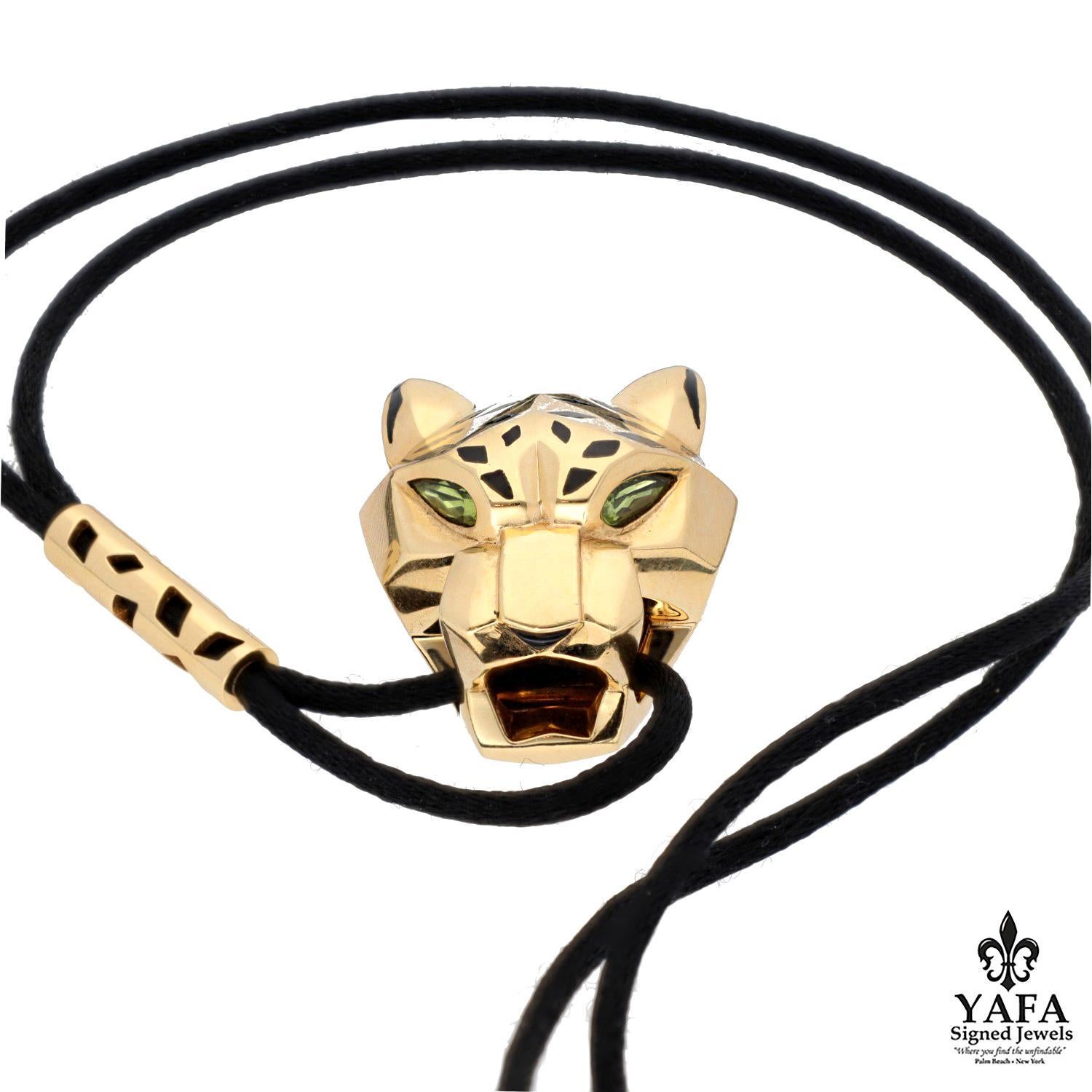 Prominently Displaying Cartier's Signature Panthere Composed in 18K Yellow Gold, Black Lacquer, and Pear-Shaped Peridot That Eliminate the Eyes.
Pendant on a Long Adjustable Silk Cord Containing Gold Stations set with Black Lacquer.
Circa -
