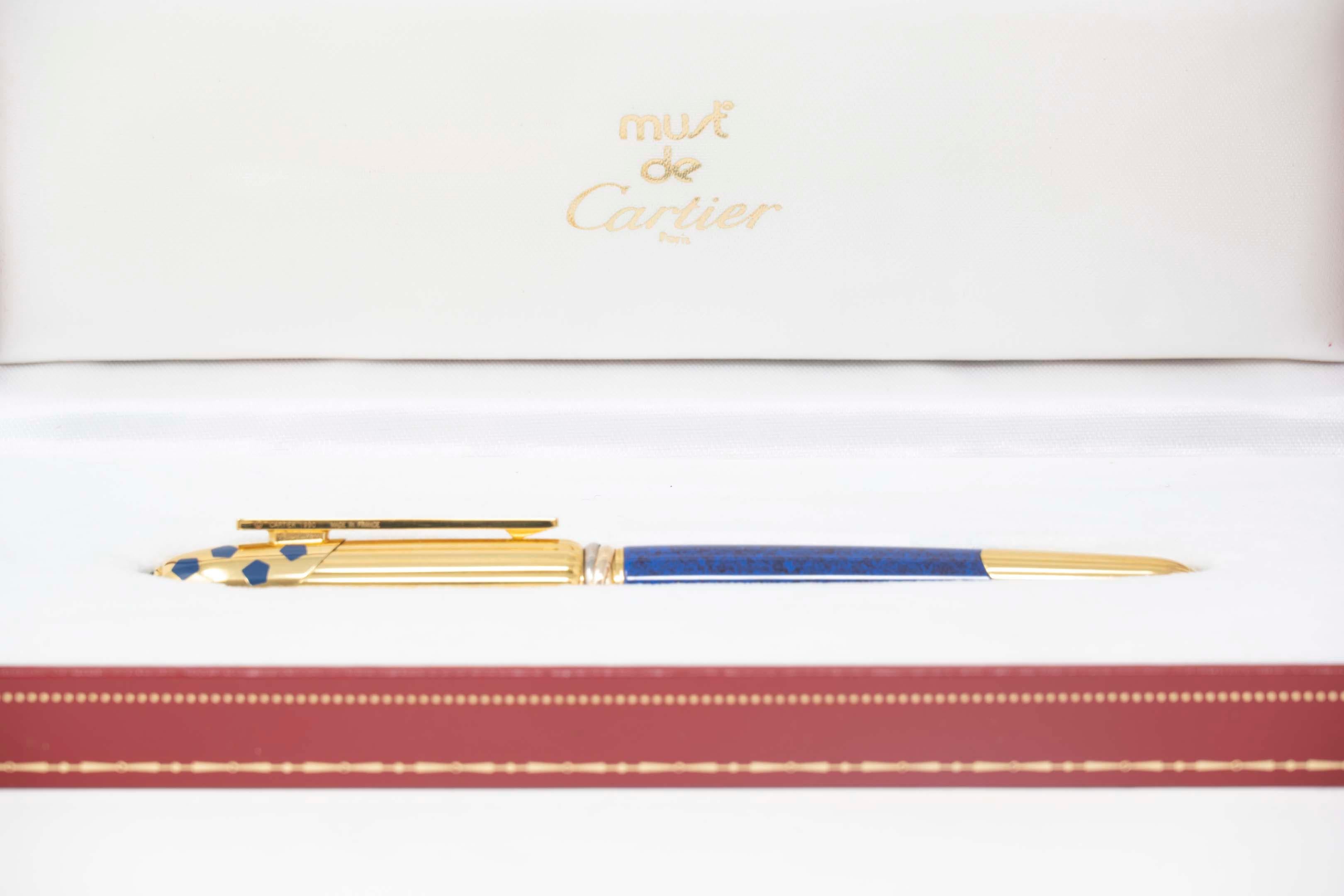 Cartier fountain pen Panthere in yellow goldplated steel and blue enamel, vertical Godron decoration. #070154 with box and certificate of Cartier, NIB 18k gold, enamel, goldplated steel, spotted lacquer. Measures 13 cm long, in good condition. C.