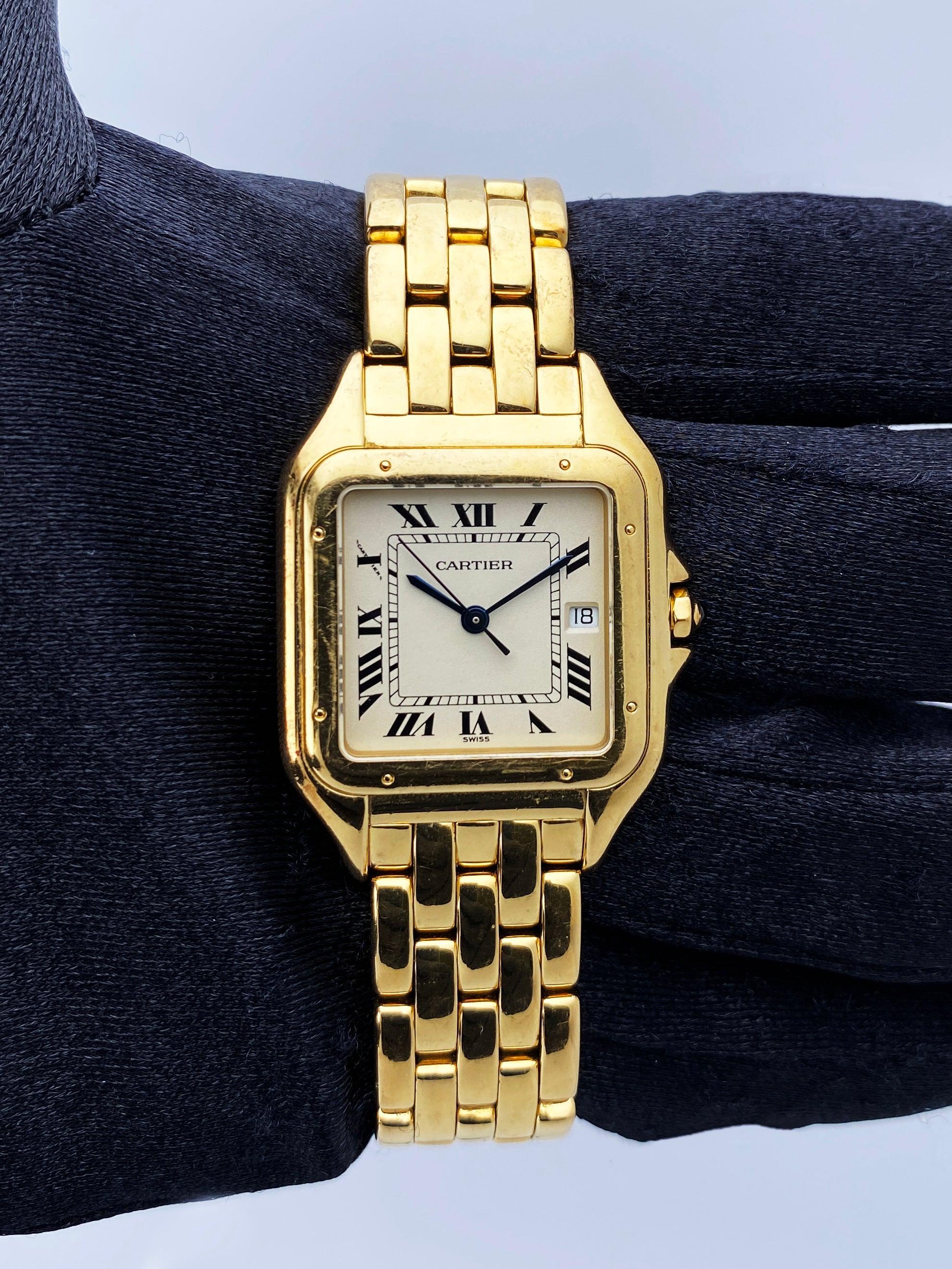 Cartier Panthere Large Mens Watch. 29mm 18K yellow case with 18K yellow gold bezel. Off-white dial with blue steel hands and black Roman numeral hour markers. Date display at the 3 o'clock position. Minute markers on the inner dial. 18K yellow