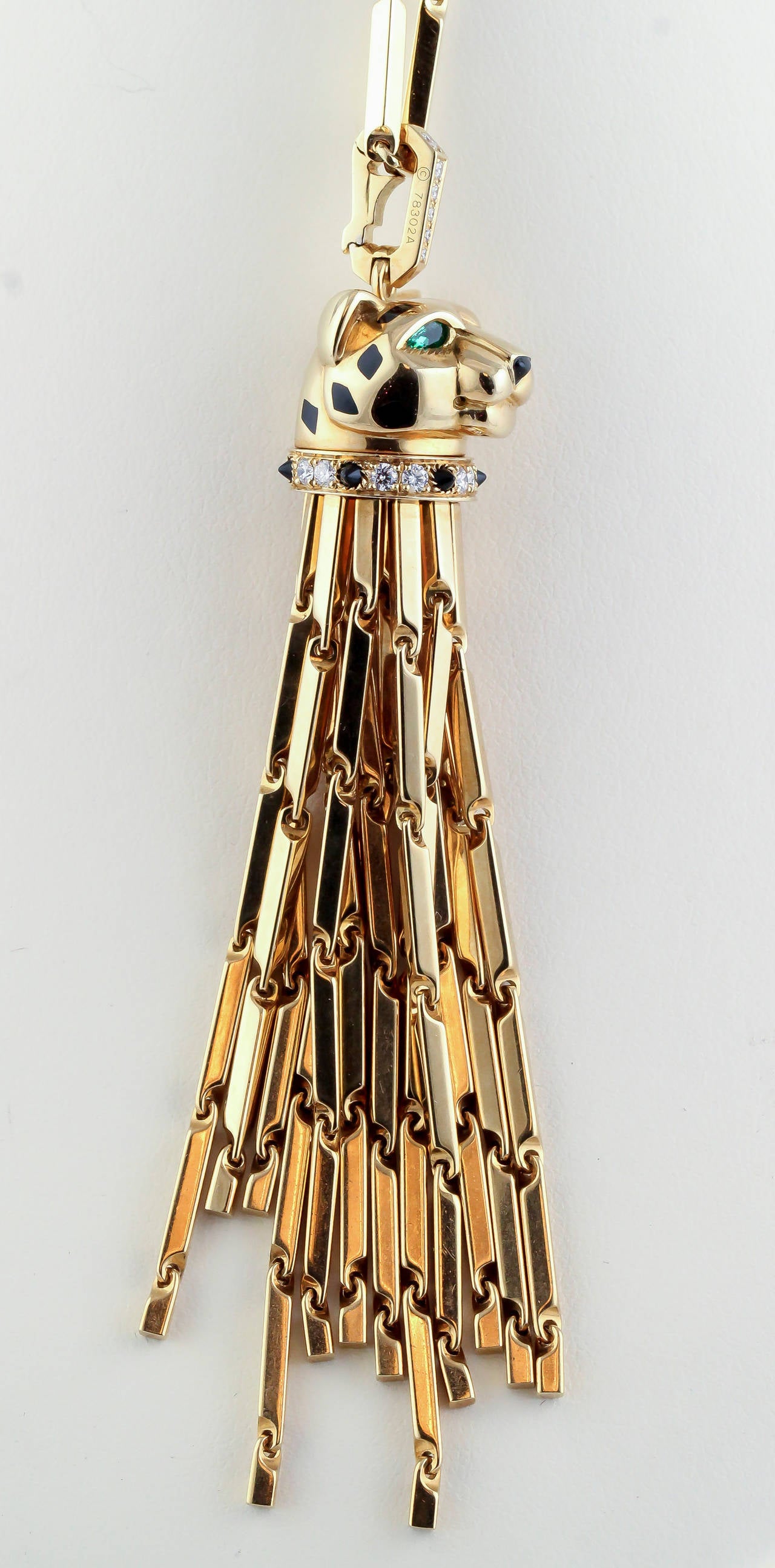 Very fine diamond, emerald, onyx, lacquer and 18K yellow gold necklace from the Panthere collection by Cartier. It features high grade round brilliant cut pave diamonds, emerald eyes on the panther, onyx nose and black lacquer spots. Necklace