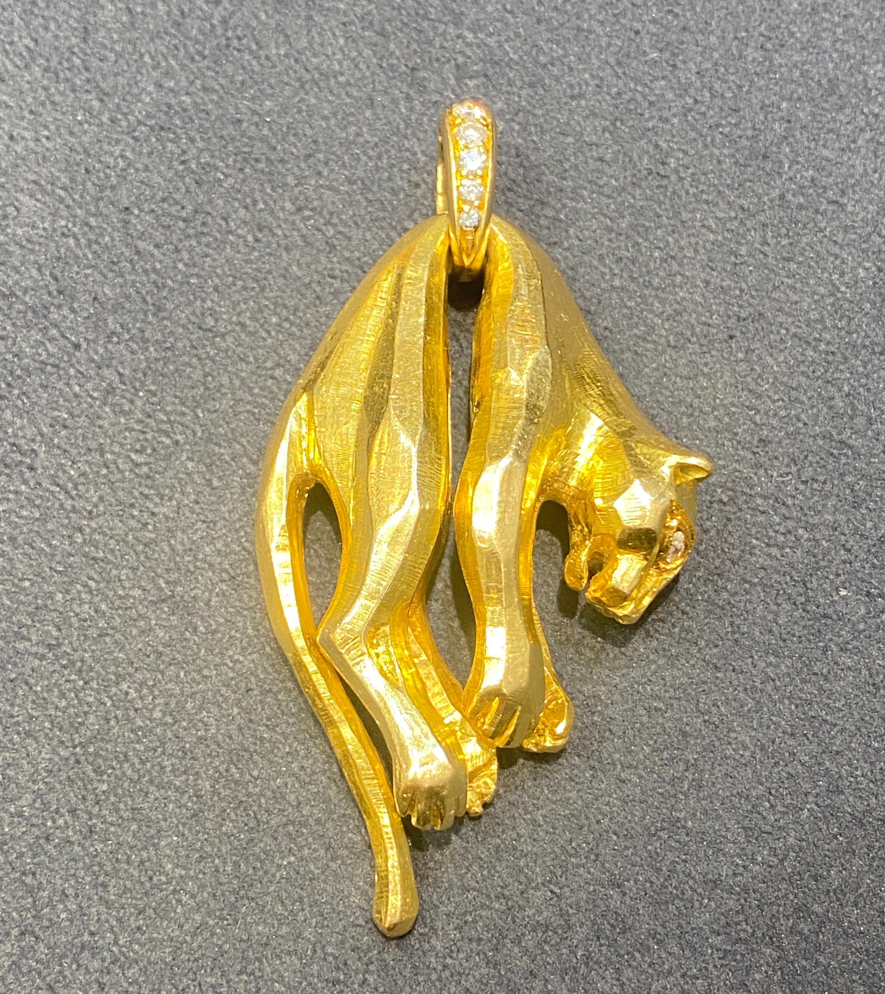 This striking Cartier panthere pendant is from 1981. Made of 18k gold the panther has marquise cut diamonds for its eye. There are also round cut diamonds on the loop holding the panther. The portrayal of the beast's body is a beautiful example of