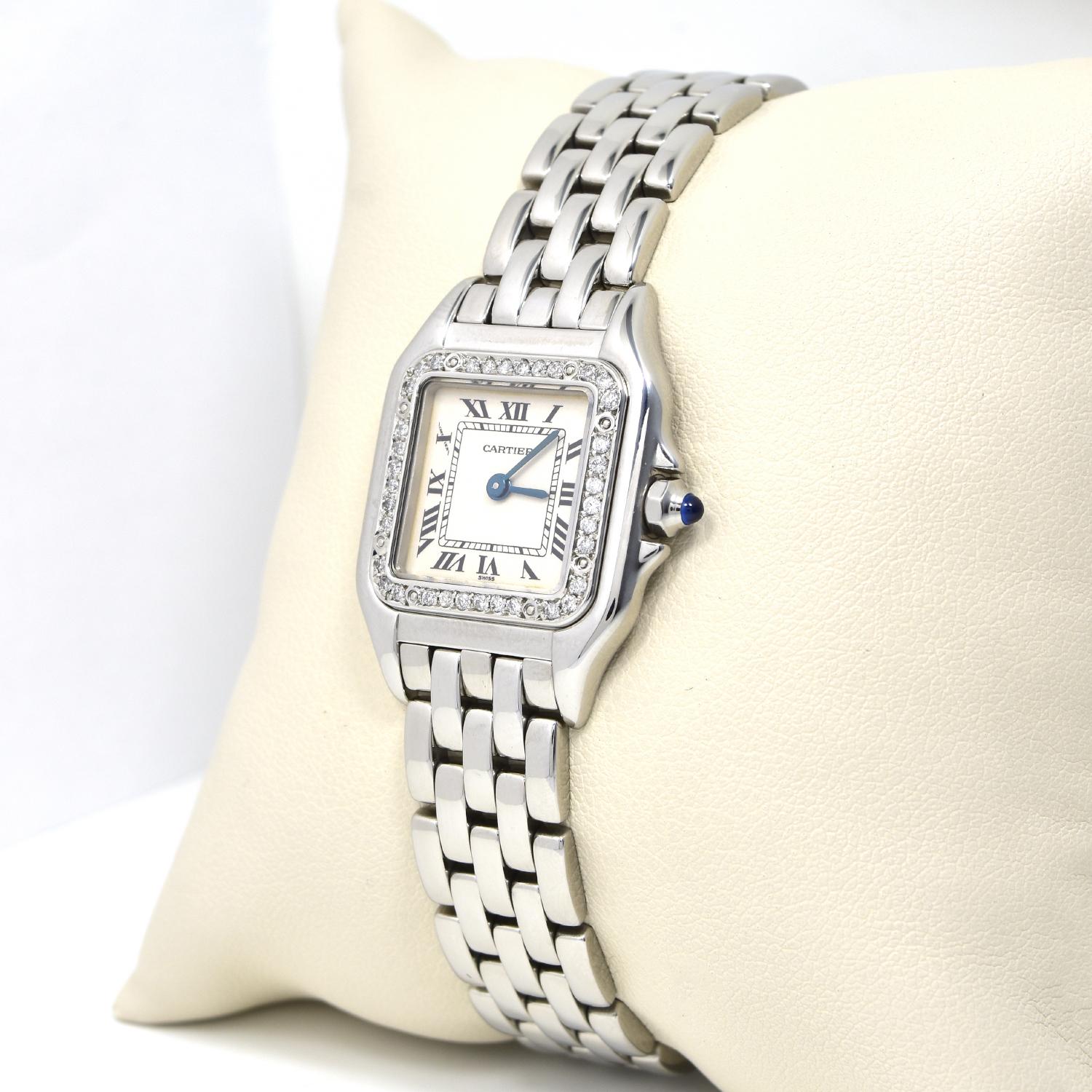 Case: 22mm Stainless steel case with custom diamonds set bezel

Dial: Gorgeous white dial with Roman numeral indexes

Bracelet: Fitted on a Stainless Steel Cartier bracelet

Accessories: Papers,

Brilliance Jewels

Notes: Elegant Cartier Panthere