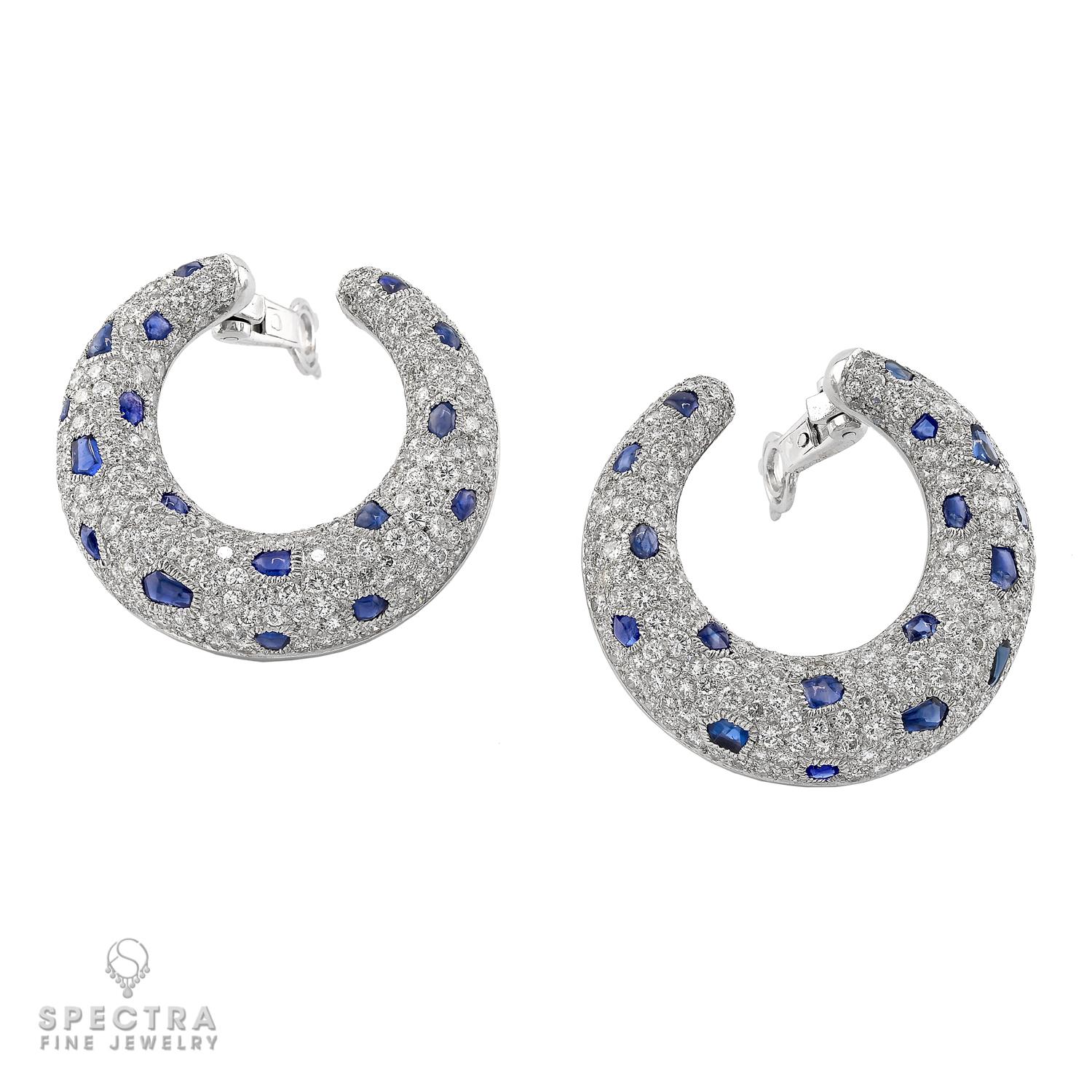 These exquisite Cartier 'Panthère' Sapphire Diamond Ear Clips are a true embodiment of luxury and elegance. Crafted in platinum, weighing 34.00 grams, these ear clips are adorned with approximately 8.83 carats of dazzling diamonds, graded F-G color