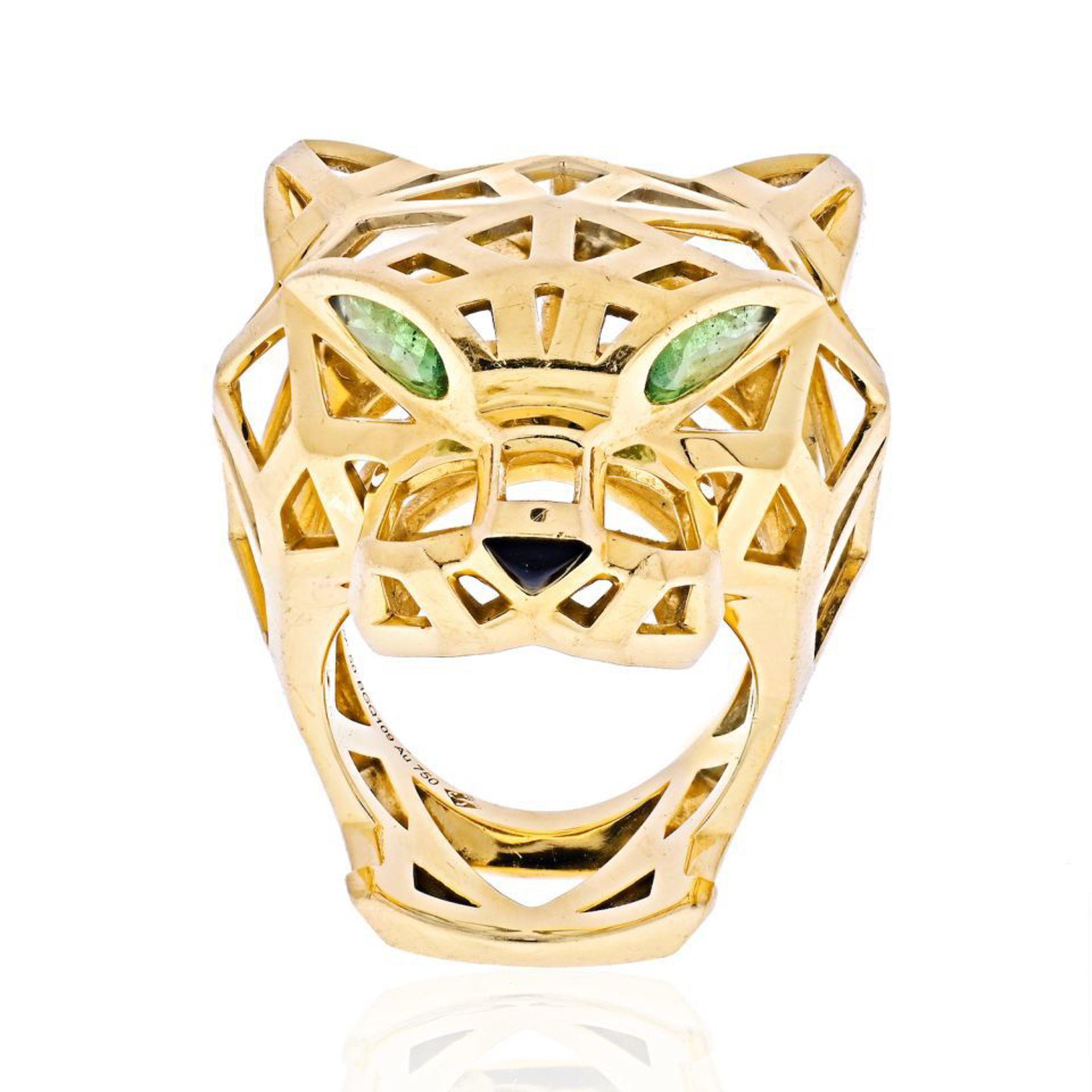 This fiercely fashionable design from the Panthre de Cartier collection is made of 18K yellow gold and boasts an almost skeleton look. Panthere de Cartier ring, 18K yellow gold, tsavorite garnets, onyx. Ring size 50 US 5.25. Ring will be lightly