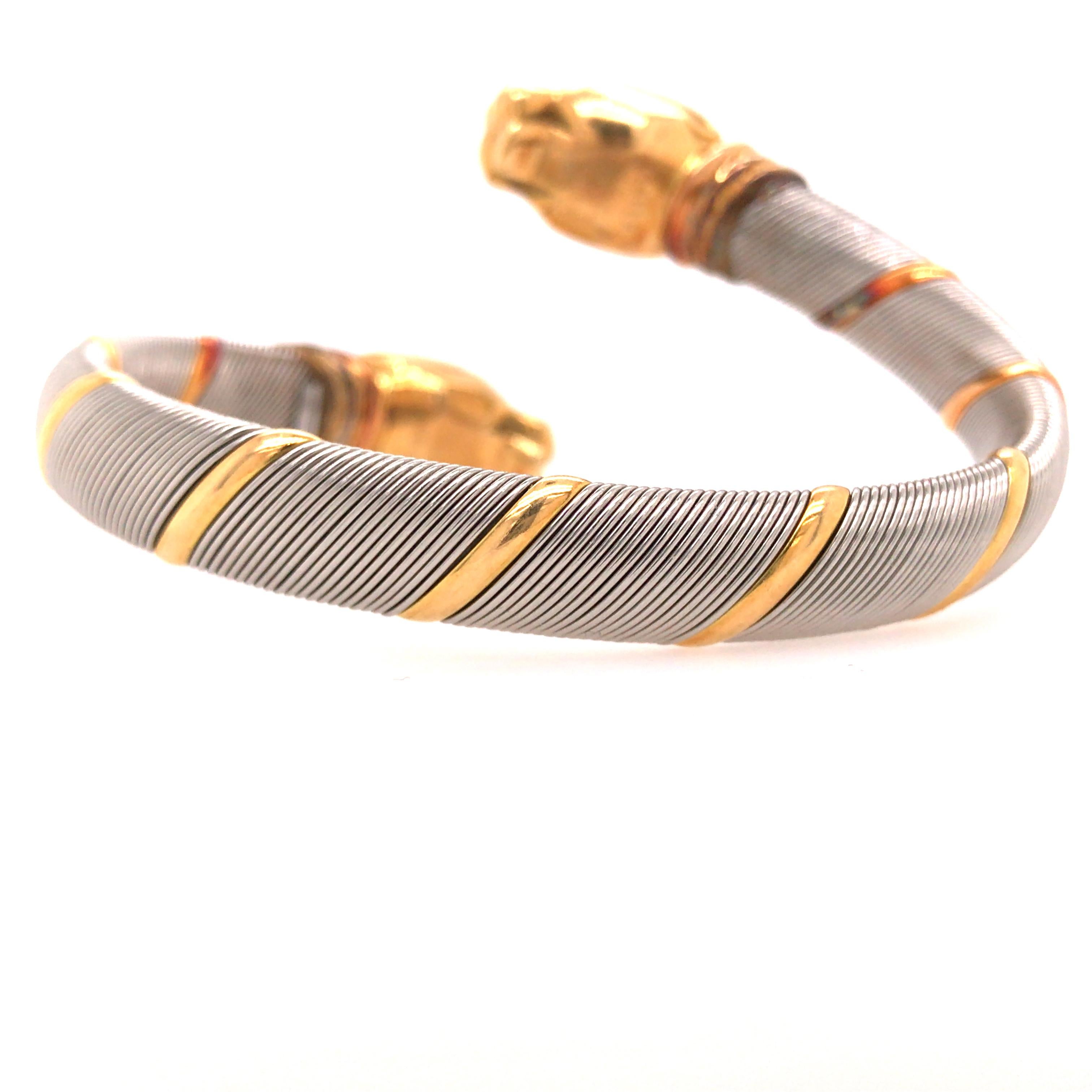 Cartier Panthere Stainless Steel 18K Tricolor Gold Crossover Bangle Bracelet.  The Bangle is made of Stainless Steel woven with 18K Yellow Gold Bands.  Partially flexible, easy to put on and remove yet secure.  Each Panthere head measures 3/4 inch