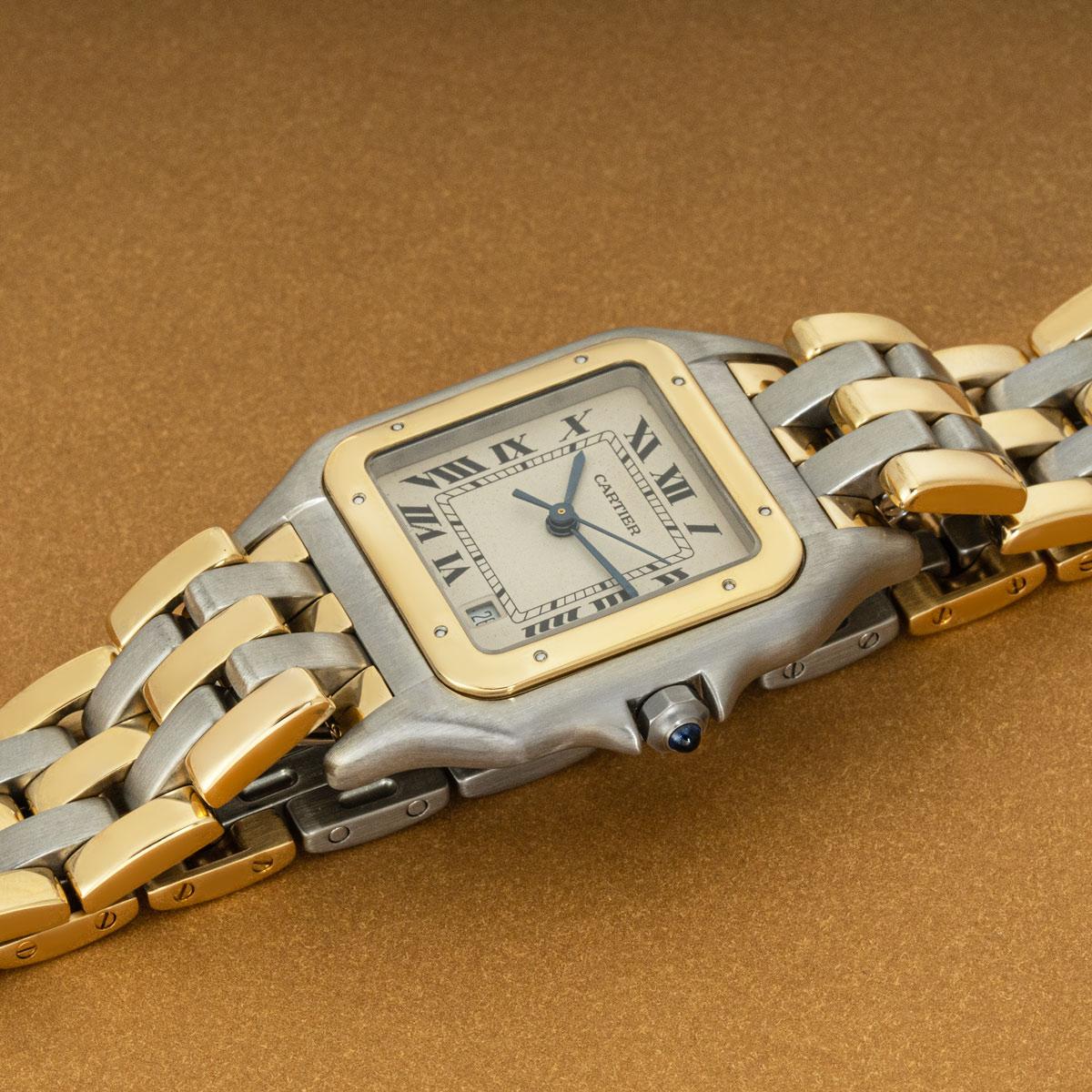 A 27mm Panthere by Cartier, in stainless steel and yellow gold. Features a silver dial with roman numerals, secret Cartier signature at V of VII, a date display and blued steel sword-shaped hands. Equipped with a steel and gold bracelet which is