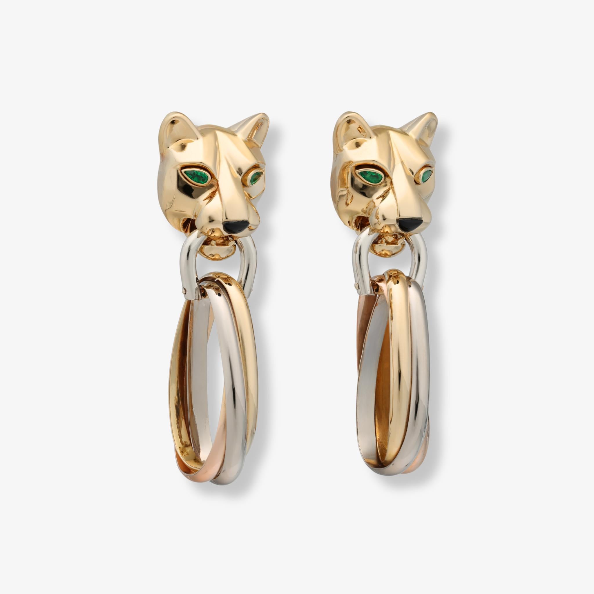 Un paio di orecchini a forma di pantera di Cartier, realizzati in oro tricolore e con occhi di smeraldo sfaccettati.

Questi orecchini a battente con pantera di Cartier mostrano uno dei motivi più duraturi della Maison, qui reso in una dinamica