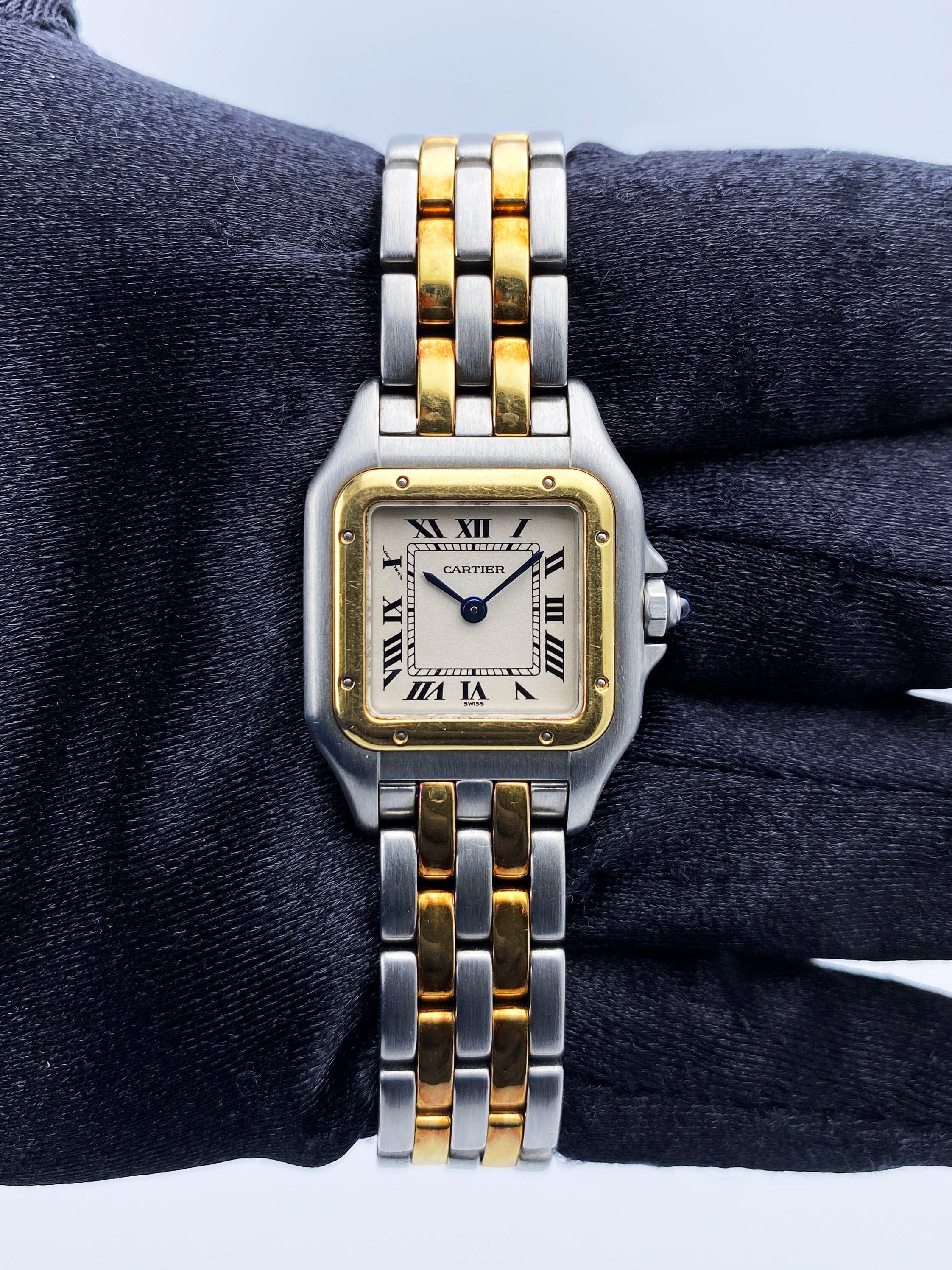 Cartier Panthere W25029B6 / 1120 Ladies Watch. 22mm stainless steel case. 18K yellow gold bezel. Off-White dial with blue steel hands and Roman numeral hour markers. Minute markers on the inner dial. Stainless steel & two rows of 18K yellow gold