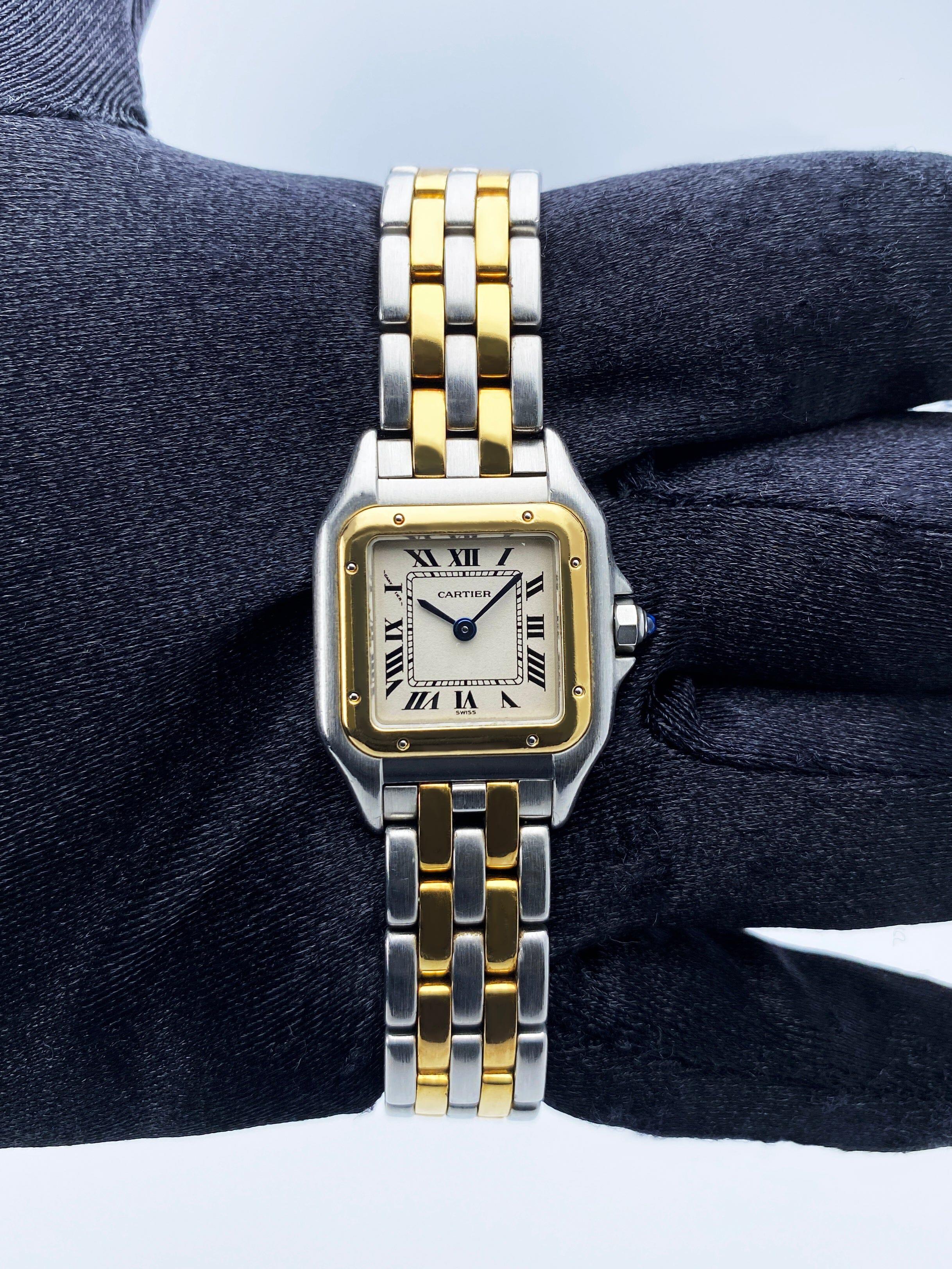 Cartier Panthere W25029B6 / 1120 Ladies Watch. 22mm stainless steel case. 18K yellow gold bezel. Off-White dial with blue steel hands and Roman numeral hour markers. Minute markers on the inner dial. Stainless steel & two rows of 18K yellow gold