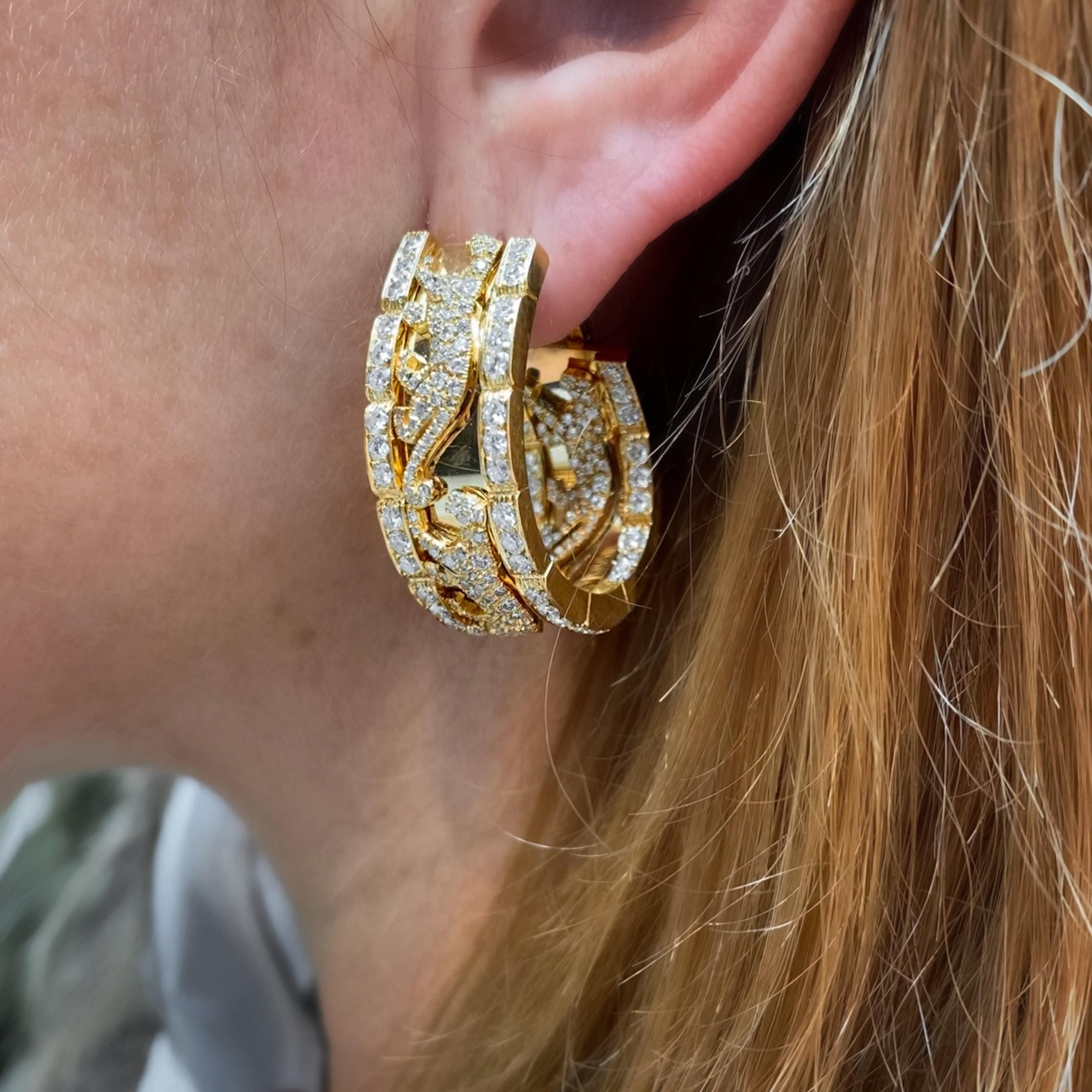 Cartier Vintage “Panthère de Cartier�” walking panther diamond hoop earrings in 18kt yellow gold, French, 1980s. A true collector’s piece, each of these earrings is designed as a wide hoop featuring three jeweled walking panthers, two on the outside