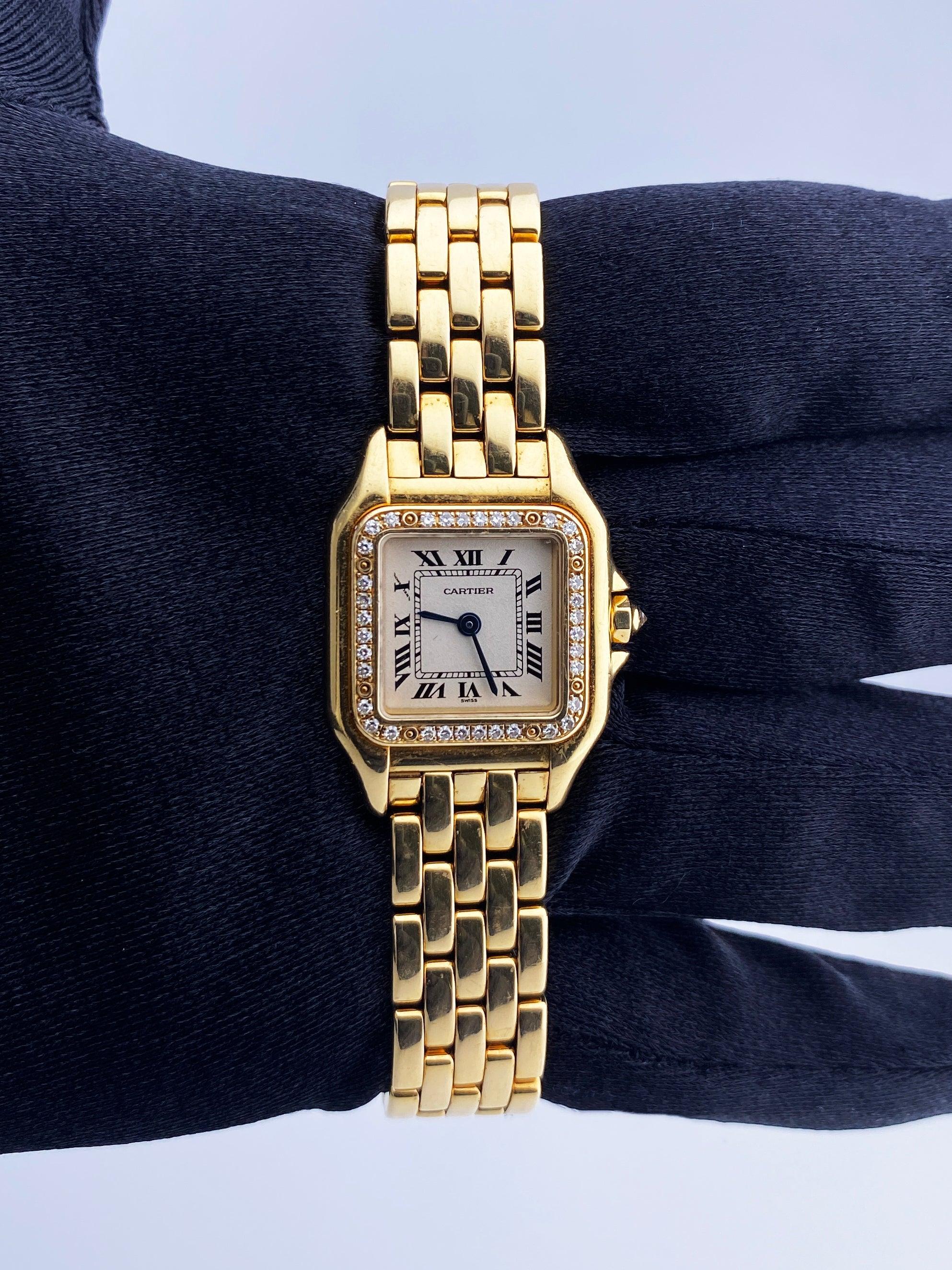 Cartier Panthere 1280 Ladies Watch. 22mm 18K yellow gold case with original factory diamond set bezel. Off-white dial with blue hands and black Roman numeral hour marker. Minute markers on the inner dial. 18K yellow gold bracelet with hidden