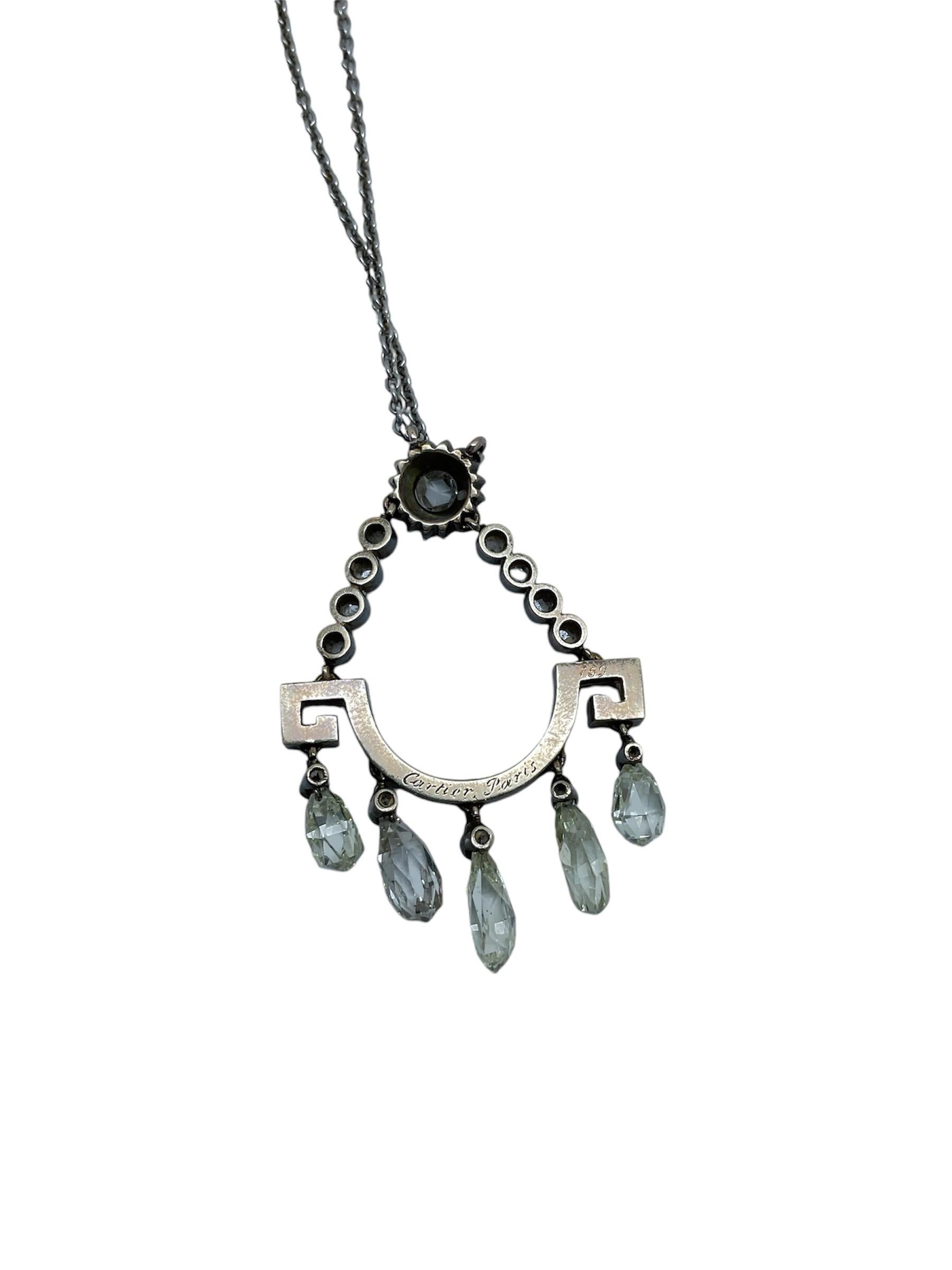 Finished catenary pendant with greek decorations on both sides. Five of them hang from this pendants, each composed of a Briolette cut diamond. From both sides of the greeks emerge two bodies of union with four diamonds Round in brilliant cut, which