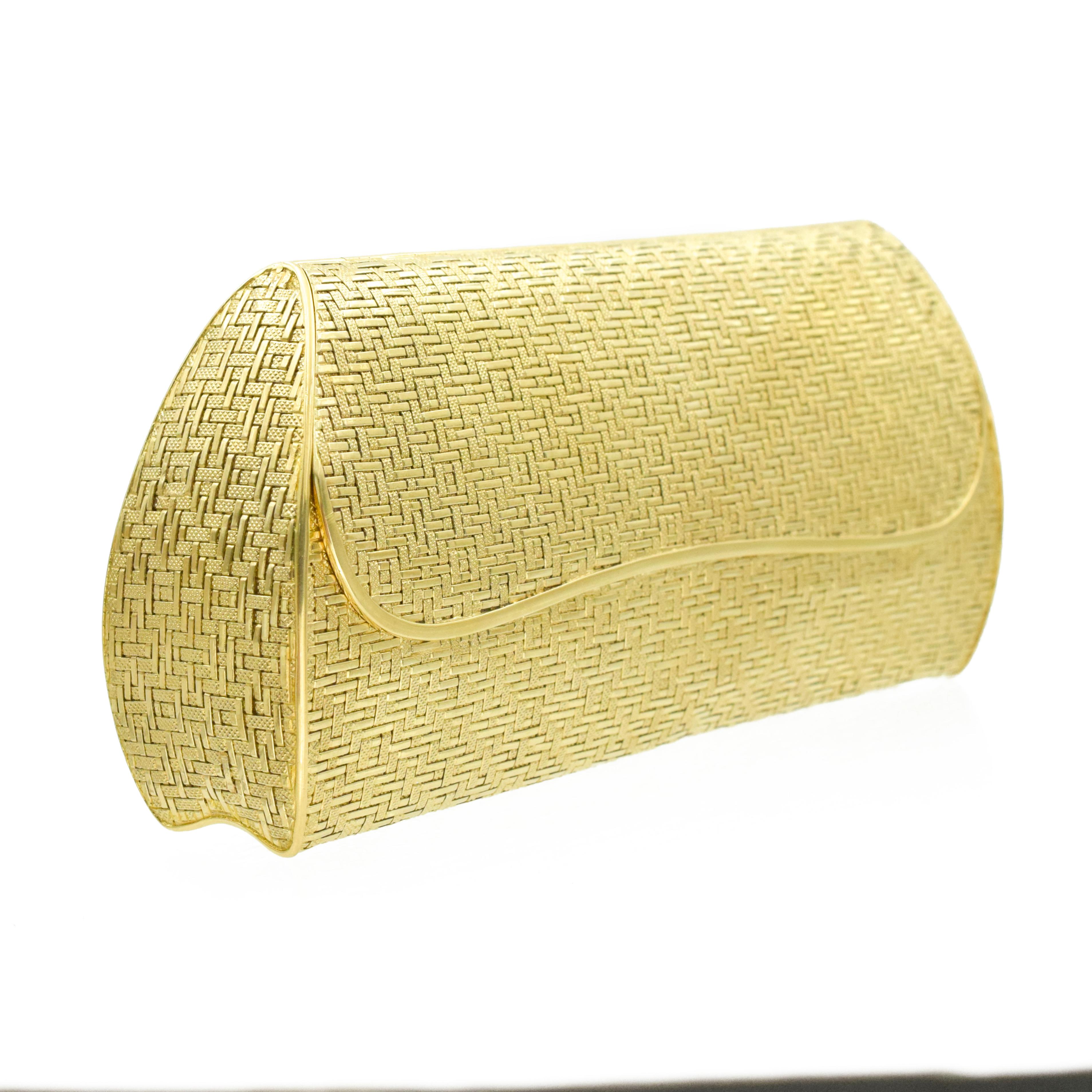 Cartier Woven Two tone 18k Gold Purse. This purse has a woven design of 18k yellow and white gold with a twisted rope chain (length 14 inches). Inside the opening of the purse is a bevelled mirror (4cm x 14-15cm) and the bottom half has a hinged