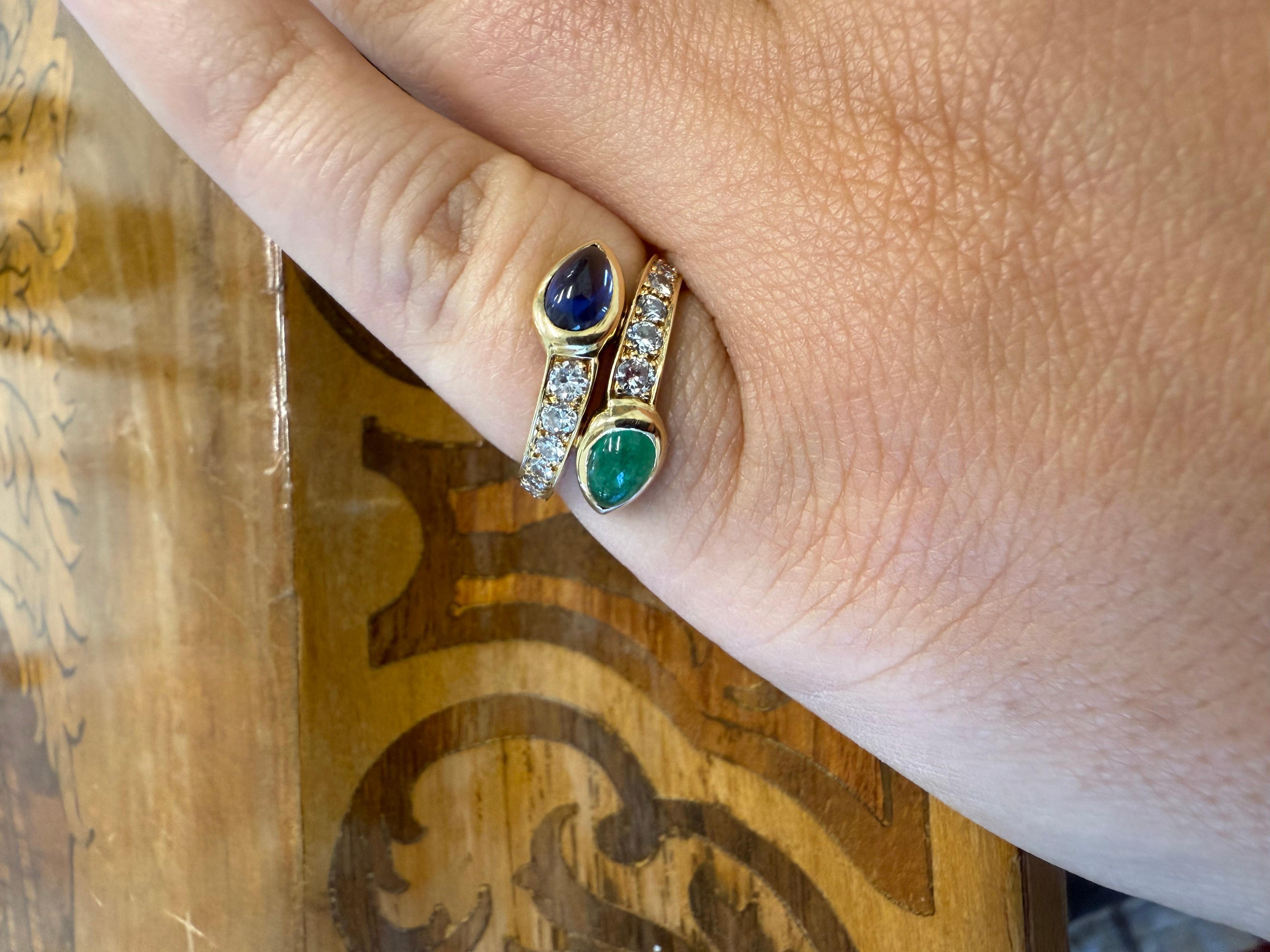 Cartier Paris 18k Yellow Gold, Emerald, Sapphire & Diamond Bypass Ring 1970s Vintage



Here is your chance to purchase a beautiful and highly collectible designer ring.


This vibrant vintage Cartier Paris ring features a rich cabochon sapphire and